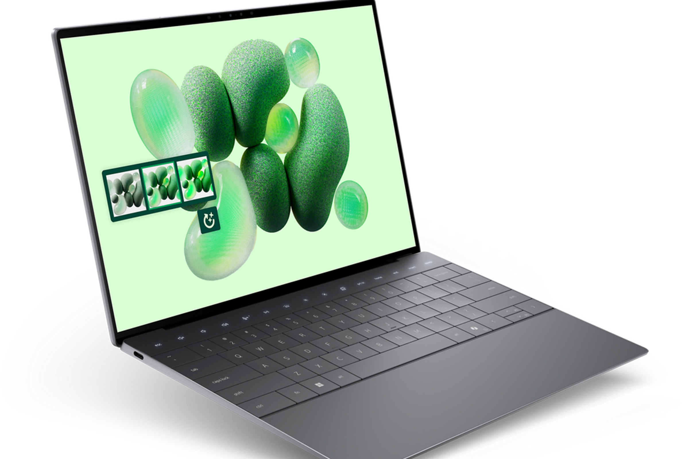 An open and powered-on laptop showing a bright green background with jellybean-like shapes