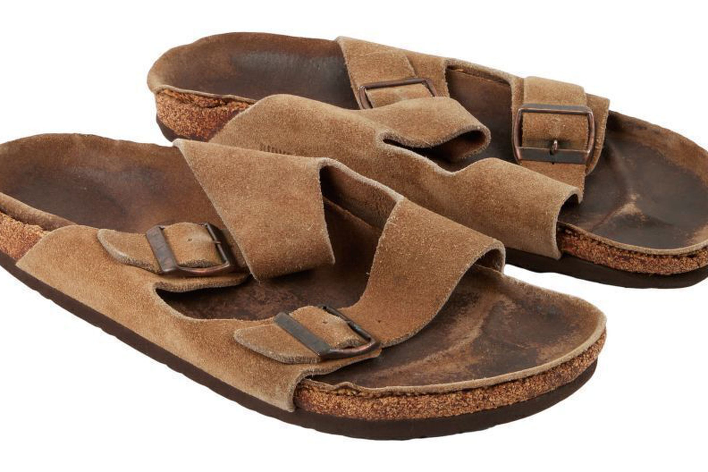 A pair of worn-out Birkenstock sandals