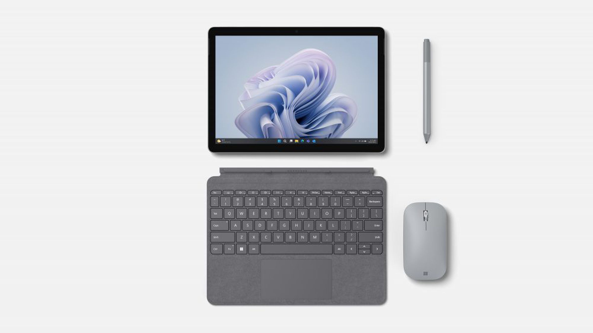 The Microsoft Surface Go 4 alongside its type cover, and Microsoft accessories.