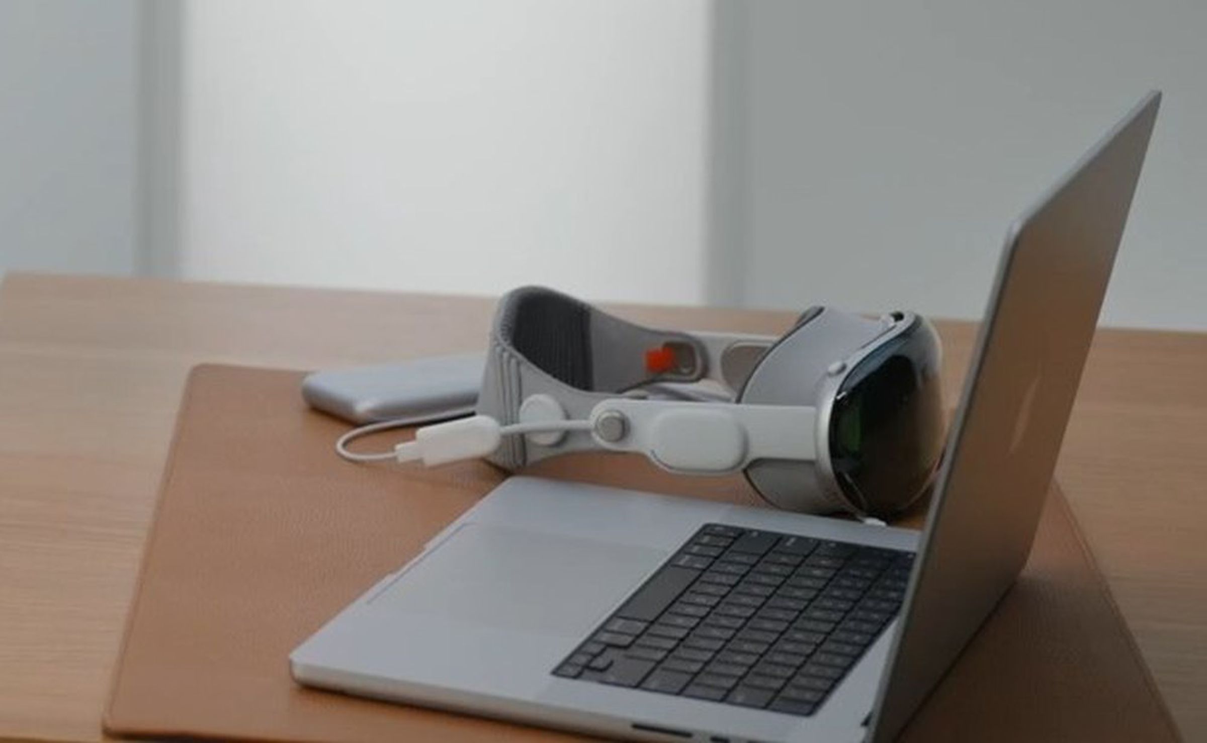 Screenshot of an Apple video showing the Vision Pro connected to a Mac via a USB-C dongle.