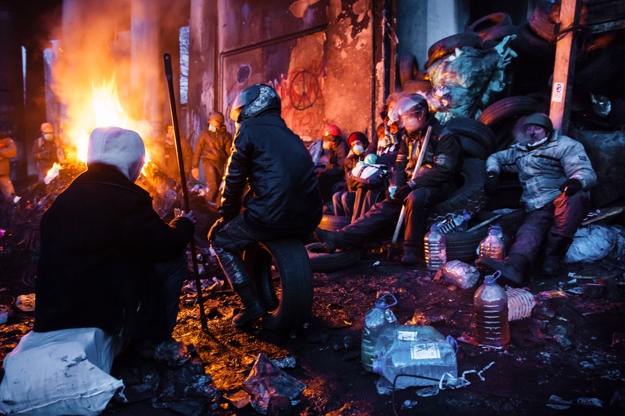 Euromaidan protesters rest and strengthen their barricades on Hrushevskoho Street after another night of clashes with riot police in Kiev, Ukraine.