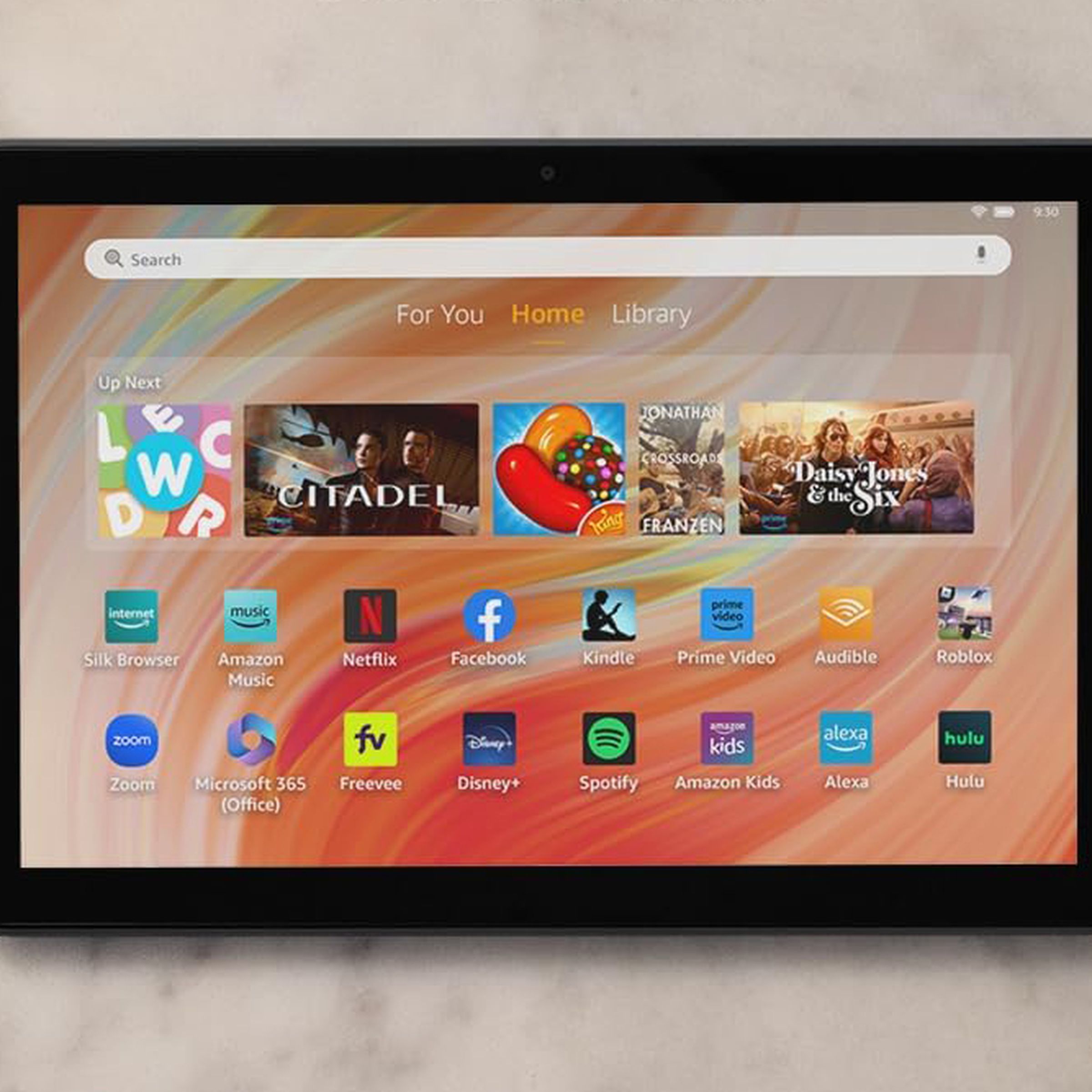 A close-up image of an Amazon Fire HD 10 tablet resting on a granite countertop from above.