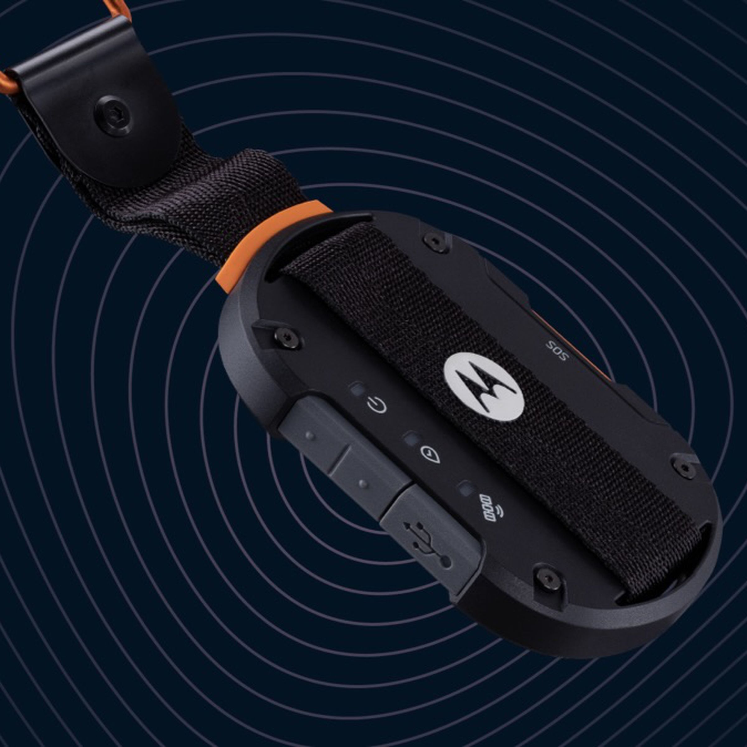 The defy satellite link looks like a car key fob on a keychain with an orange key loop. It’s got a M logo in the middle, waterproof covered USB port, and buttons on the side.