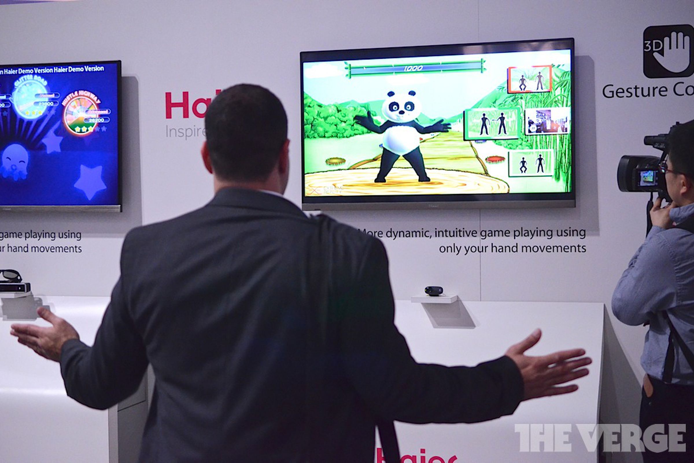 A CES-goer tries out Haier's gesture control TV