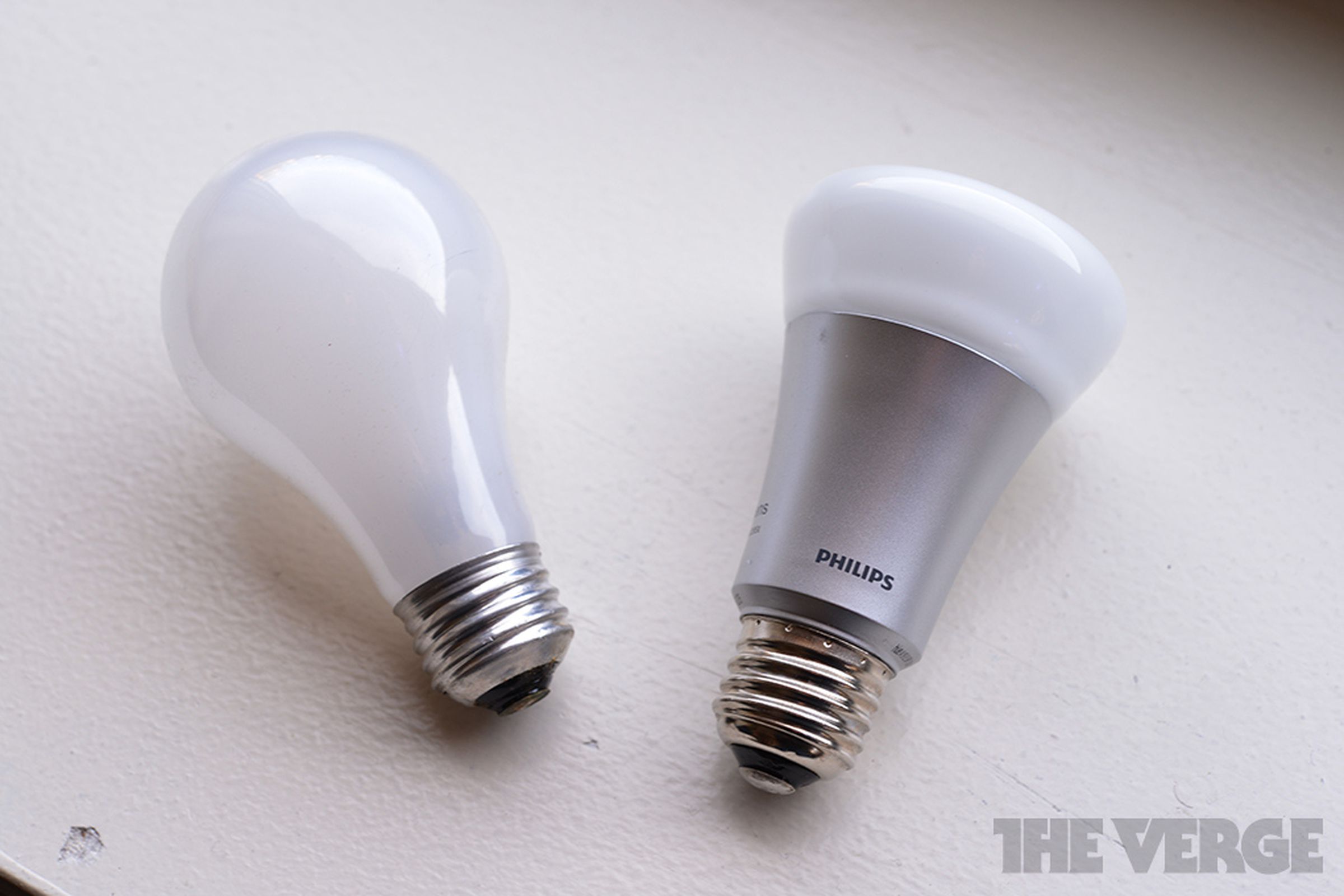 An incandescent light bulb, next to an LED bulb.