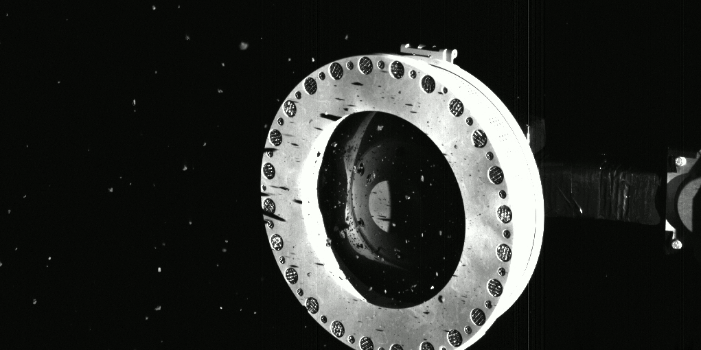 The end of OSIRIS-REx’s sample collector, showing asteroid sample leaking out into space