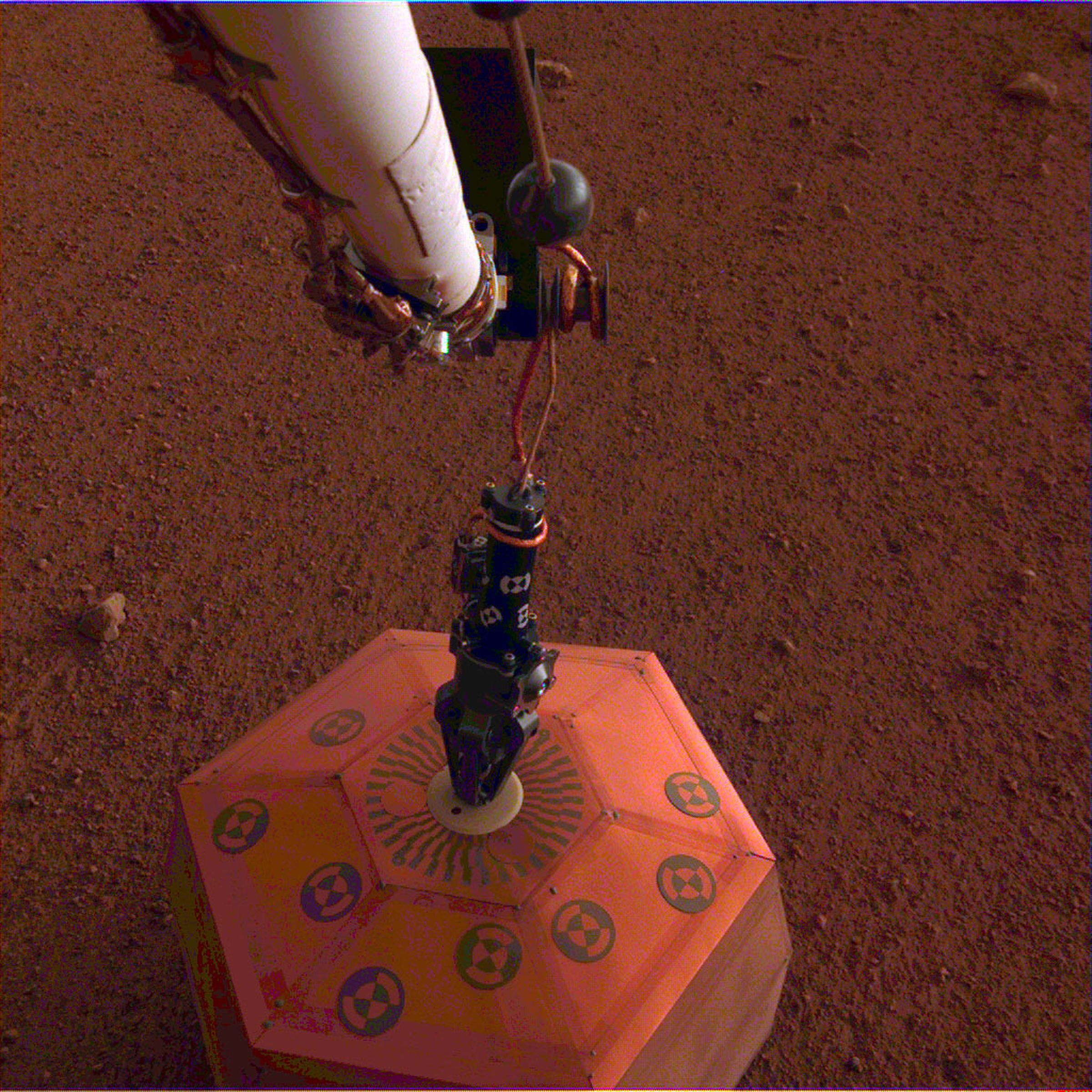 A seismometer from InSight being placed on Mard December 19th, 2018.