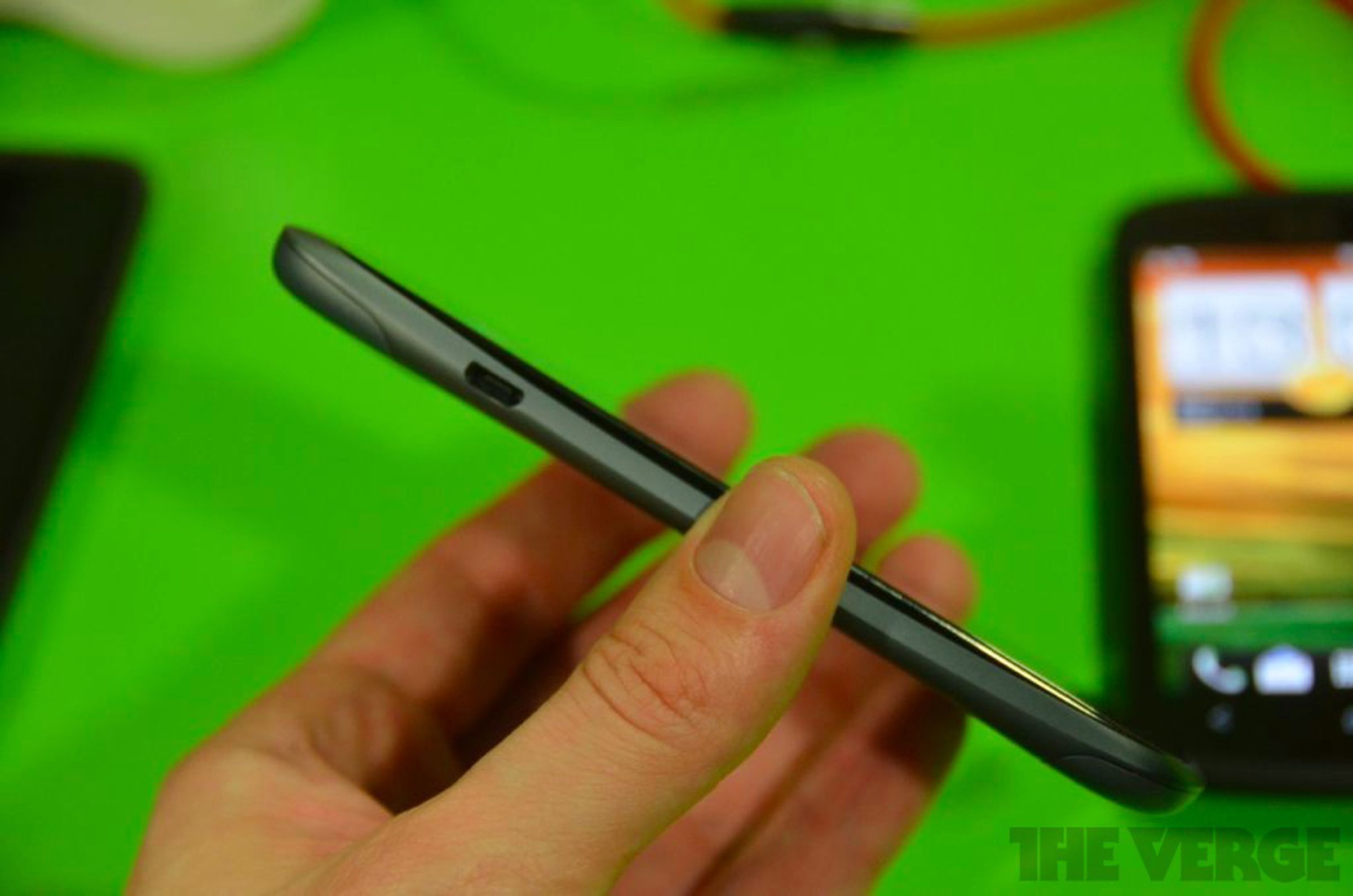 HTC One S in gray and One X in black hands on photos
