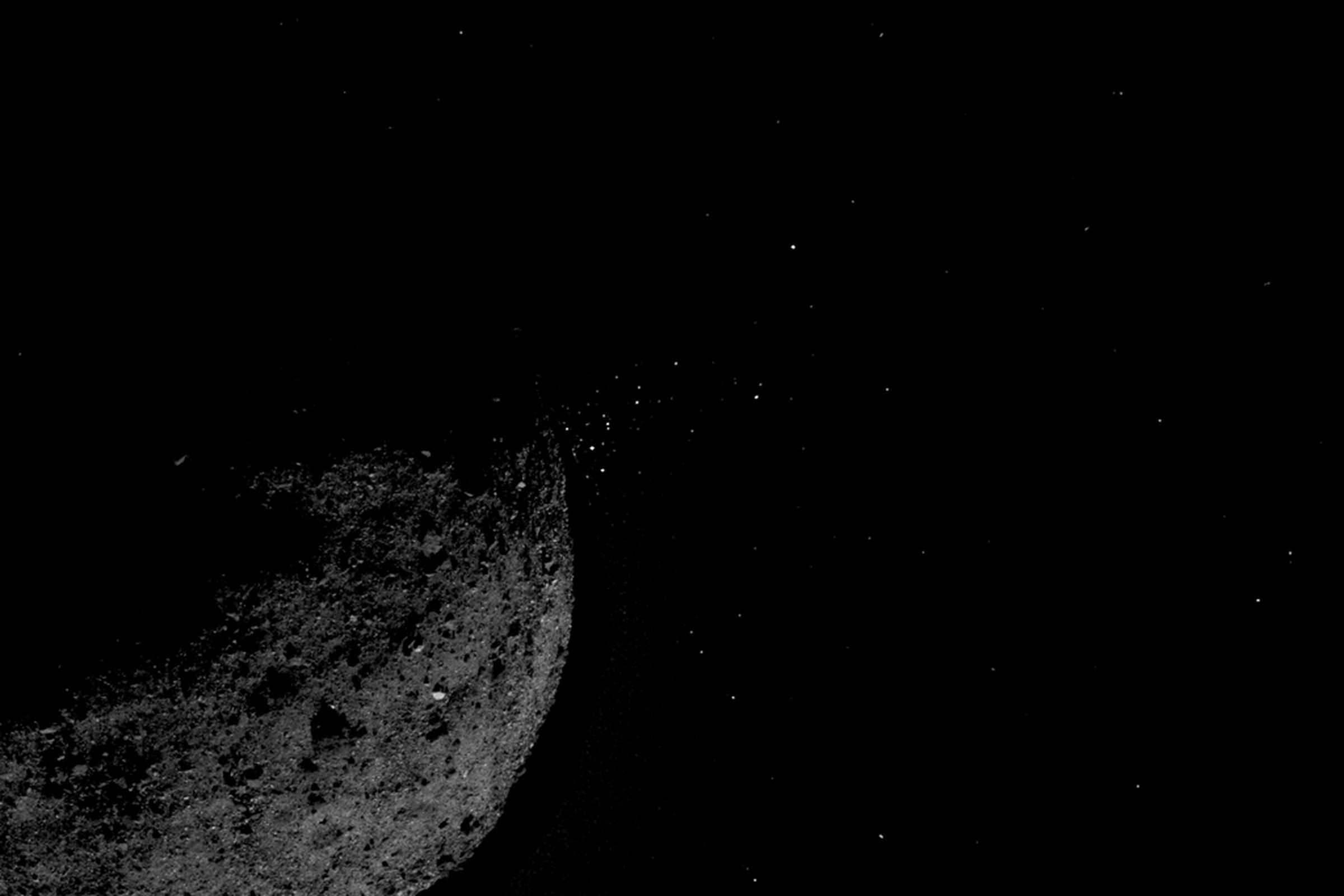 The asteroid Bennu, spewing particles into space.