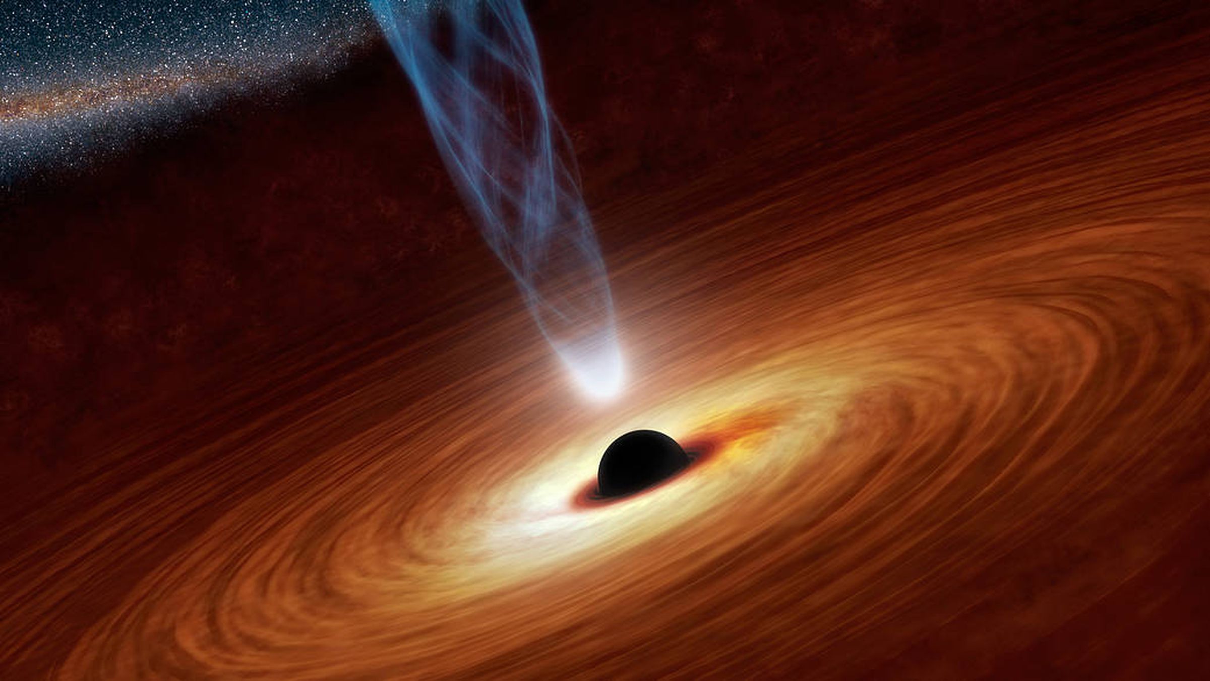 An artist’s impression of a supermassive black hole. The spiraling orange matter represents an accretion disc, while the column in the center shows a jet of charged plasma, like the one researchers have observed coming out of the black hole at the center of galaxy M87.