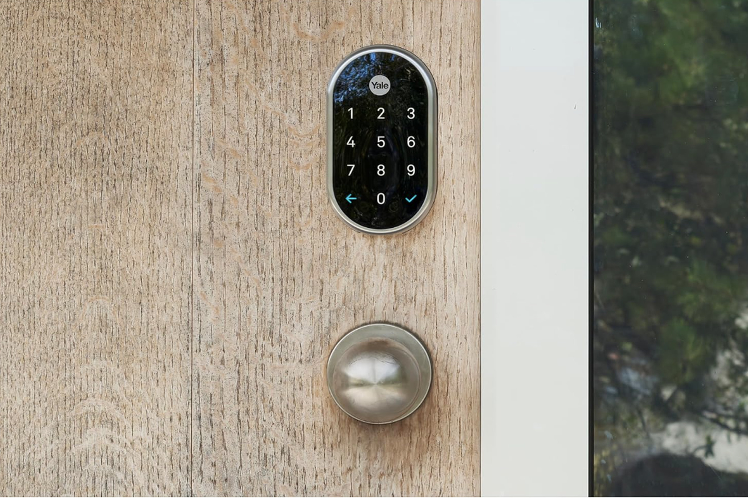 Black smart lock on a door above a doorknob