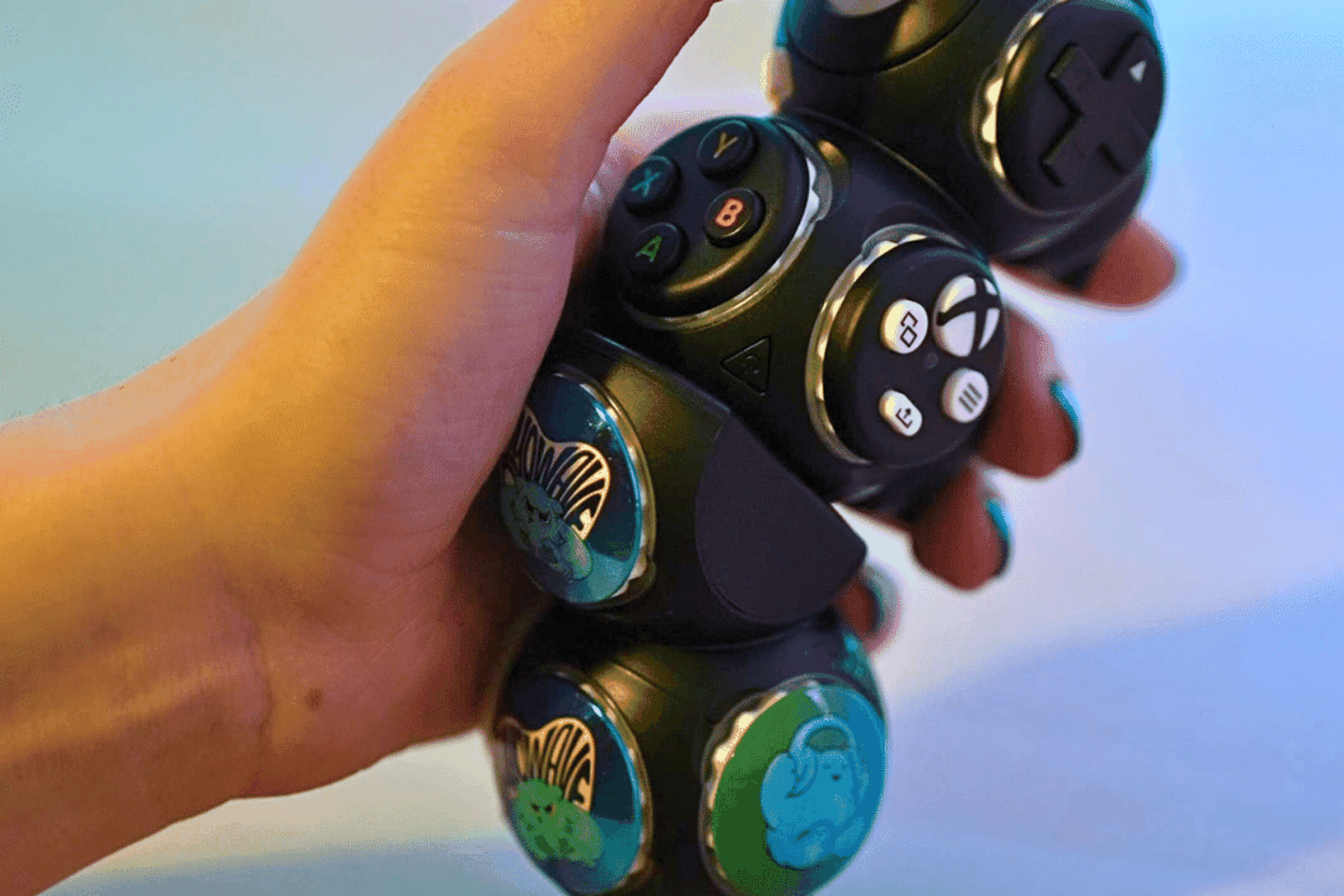 A hand holding the Proteus Controller, which consists of modular cubes.