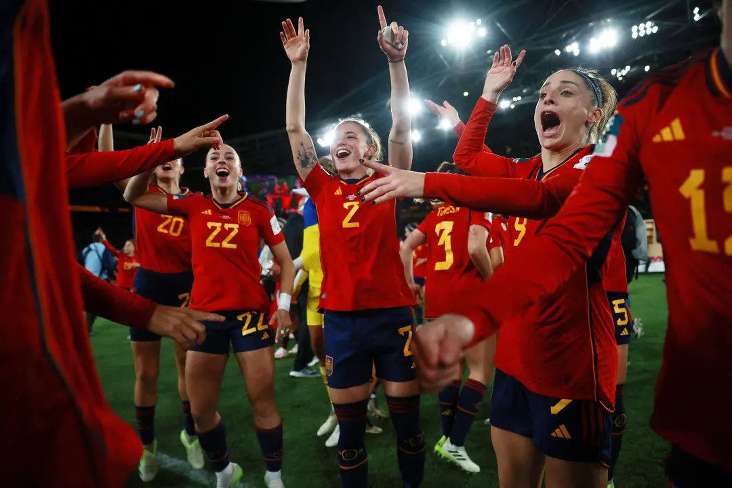 The Spanish women’s soccer team celebrating in a stadium.