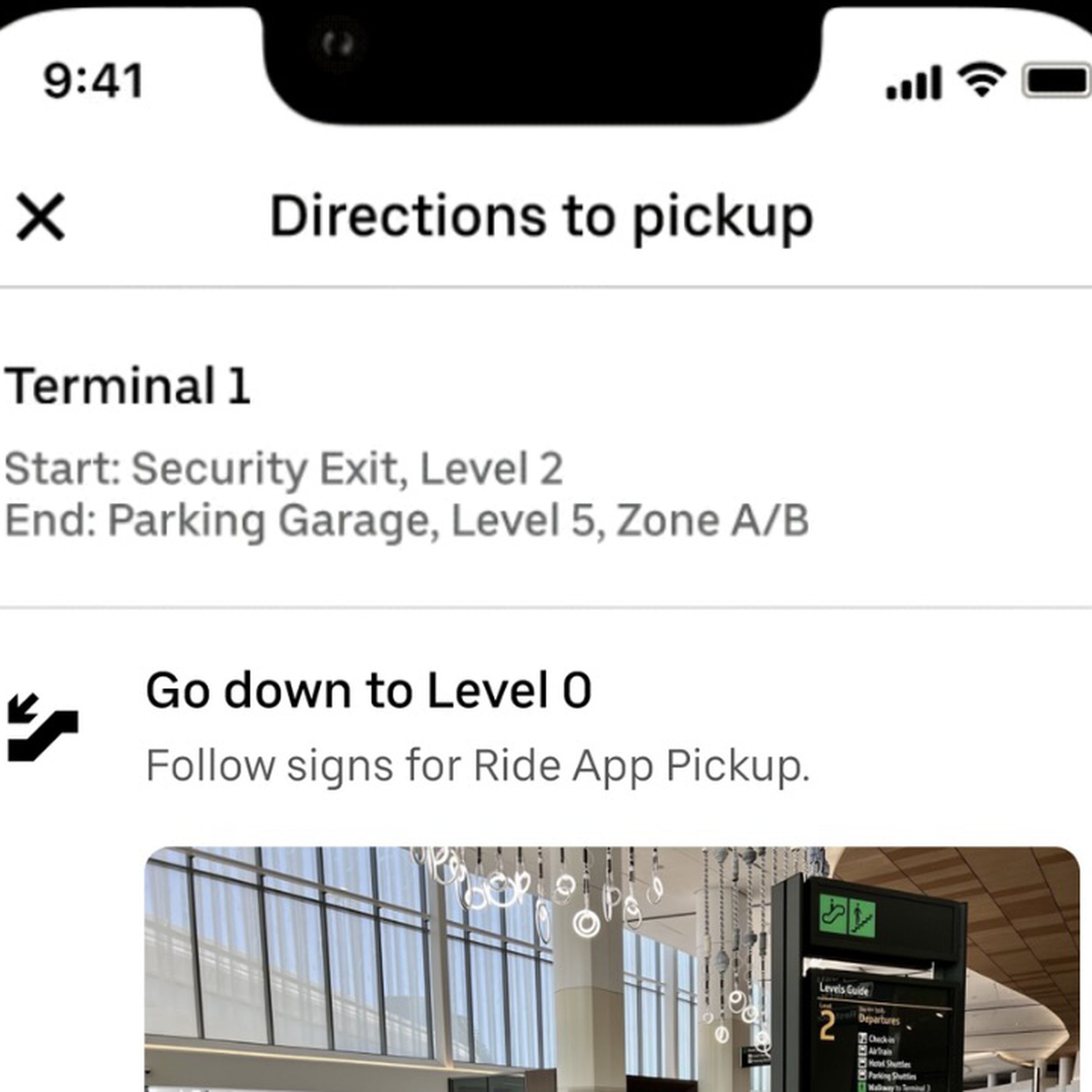 Uber app on an iPhone showing directions to pickup. The instructions for terminal 1 start at security exit, level 2 abd end at parking garage level 5 zone A B.