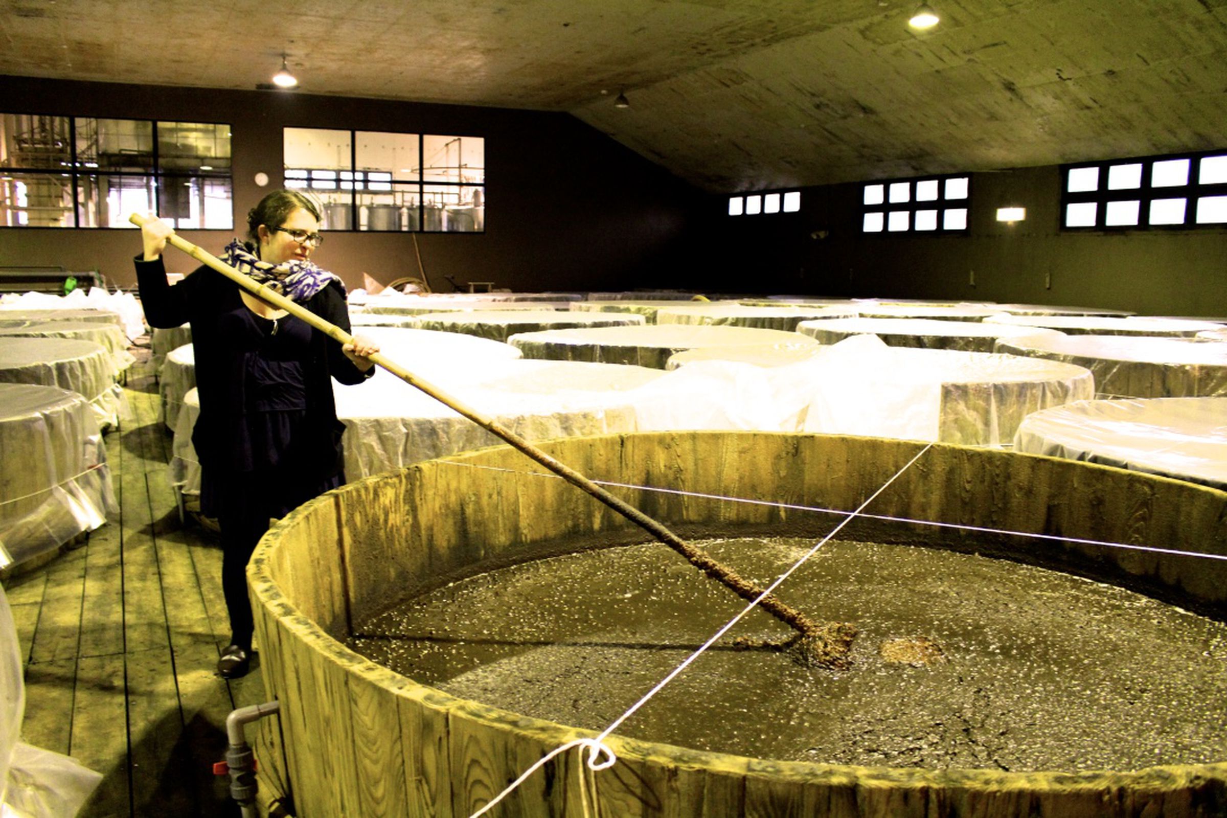 Arielle Johnson stirs a vat of soy sauce in Saitama, Japan