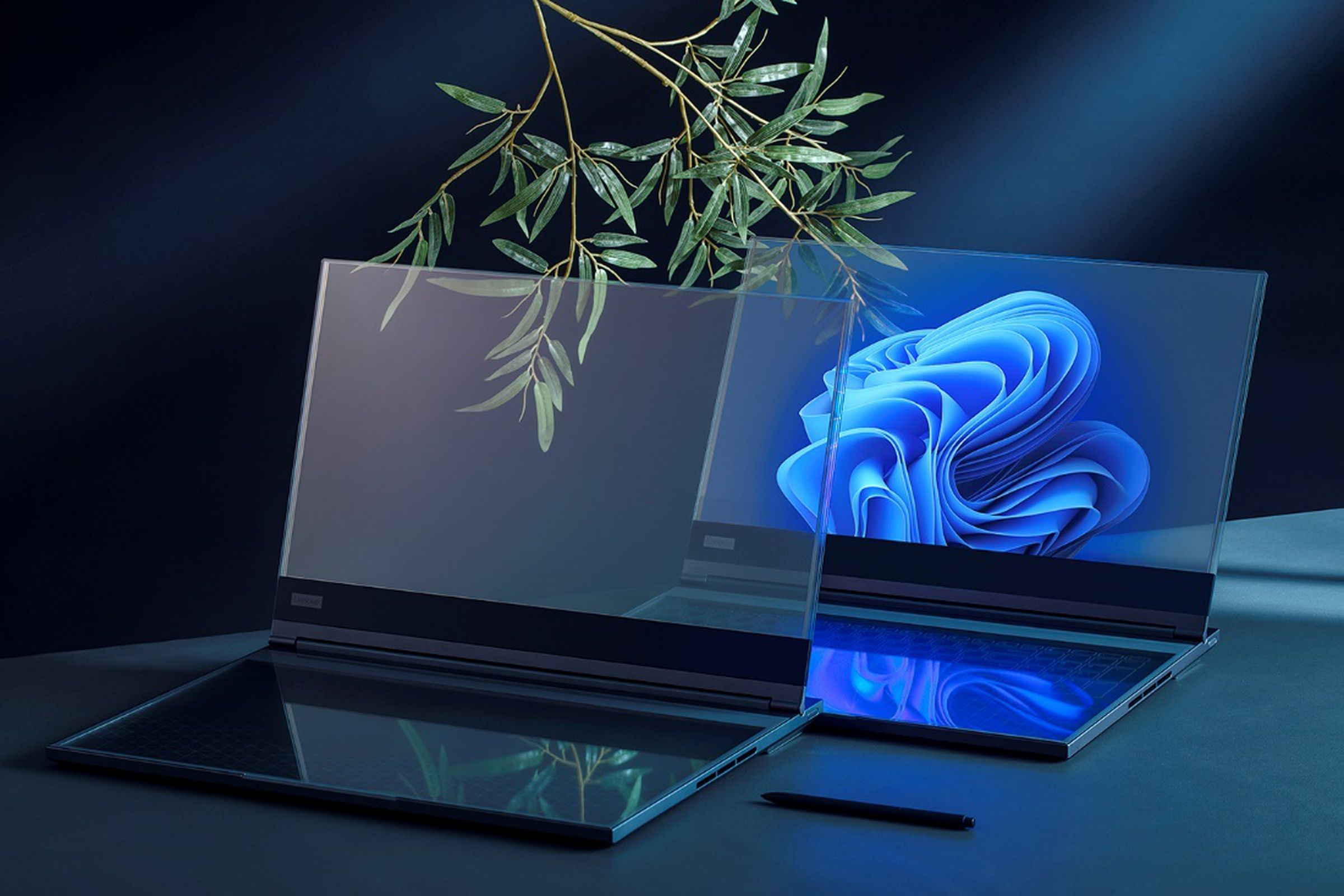 Two transparent laptop concepts sit on a desk.