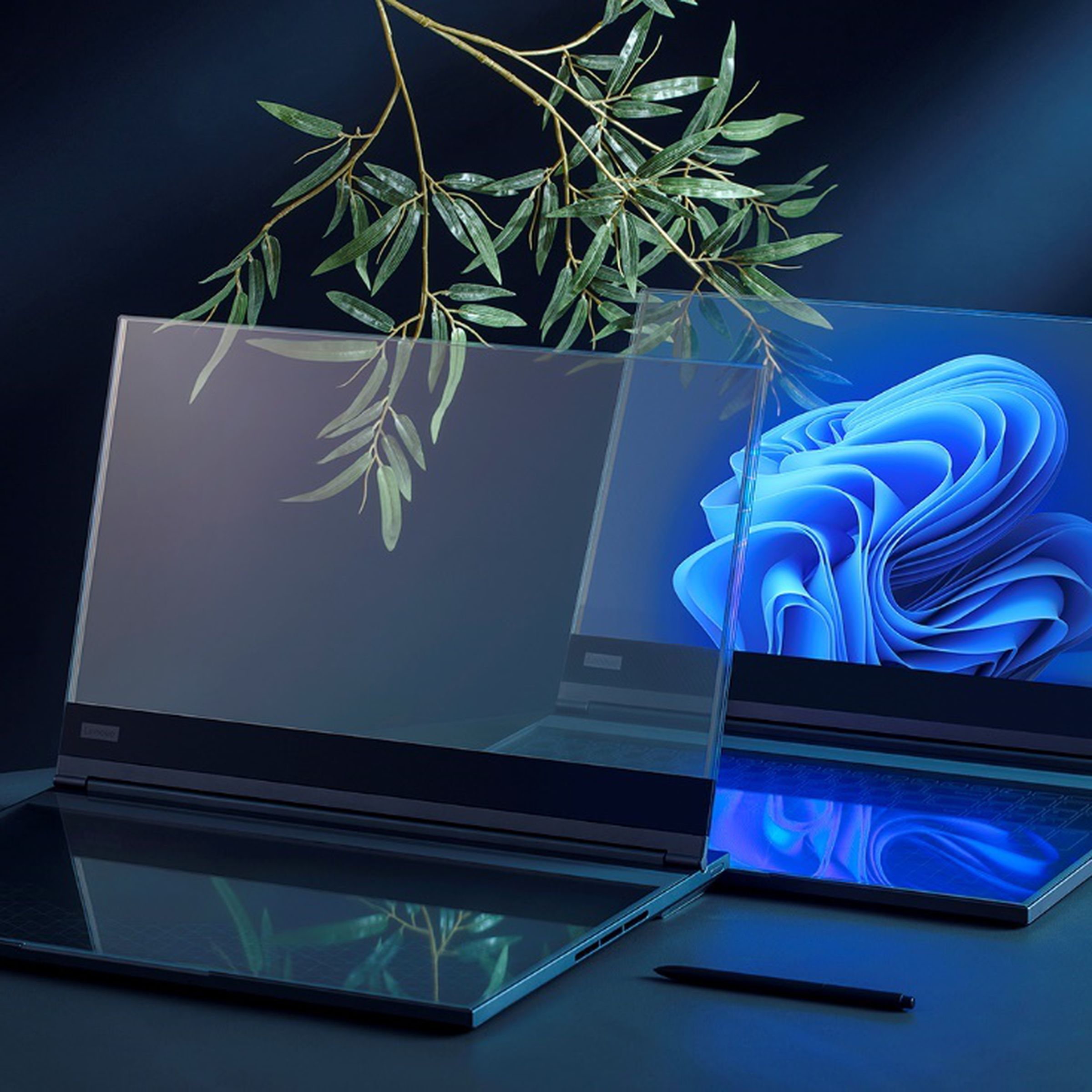 Two transparent laptop concepts sit on a desk.