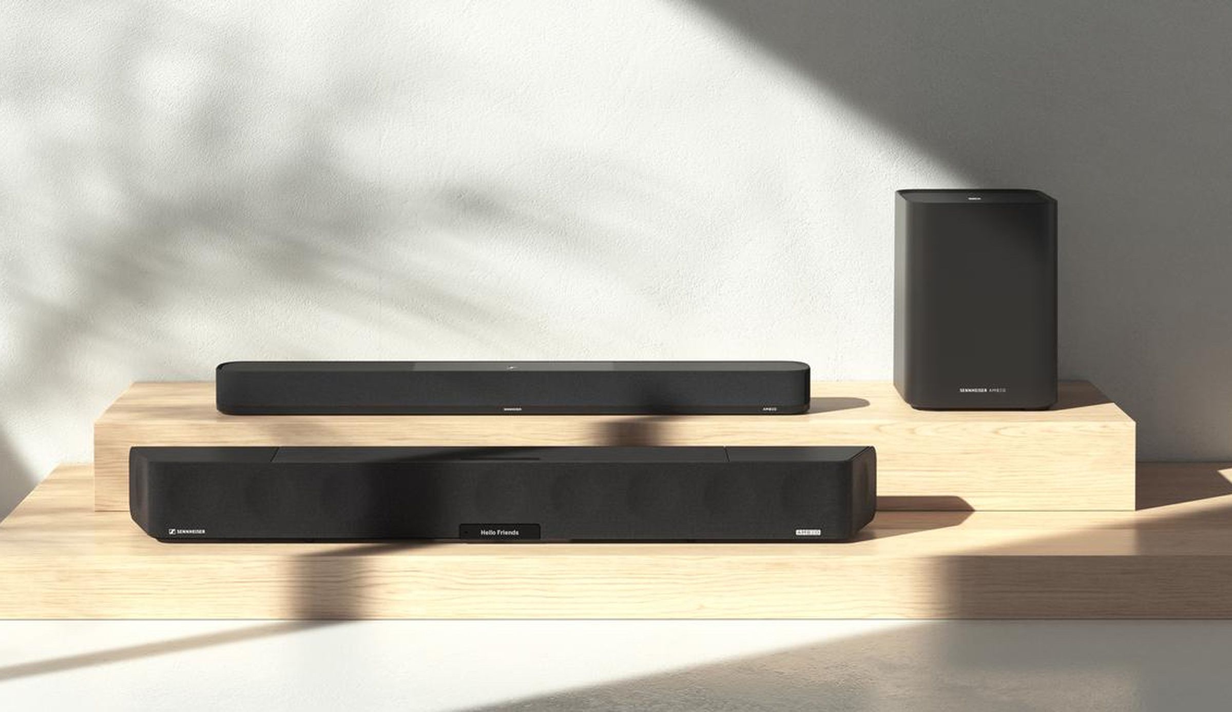 At front is the Ambeo Soundbar Max, with the new Ambeo Soundbar Plus behind it and the Ambeo Sub to the right.