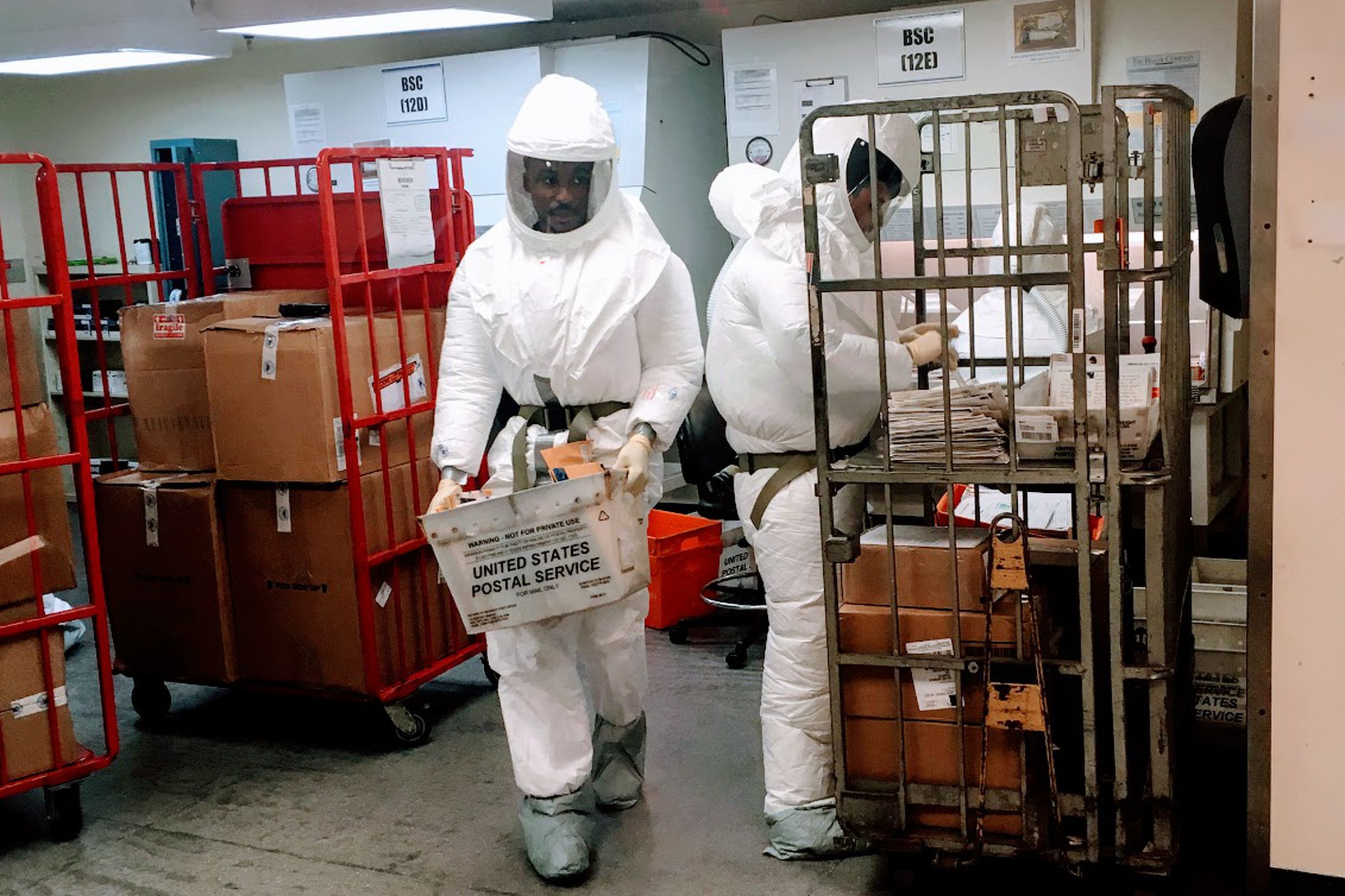 People in protective gear screening mail at a Pentagon mail facility.