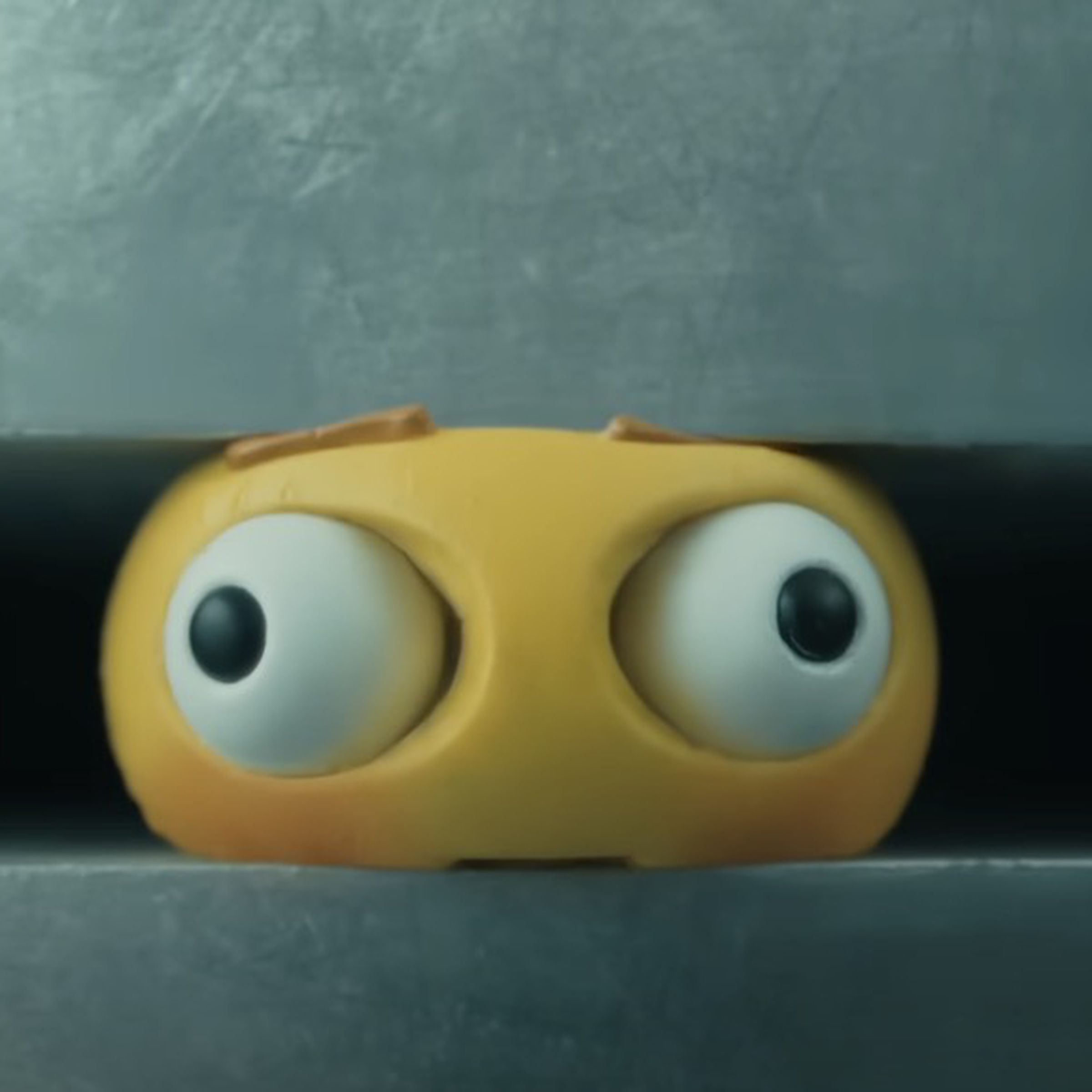 An image of an emoji crushed in a giant hydraulic press.