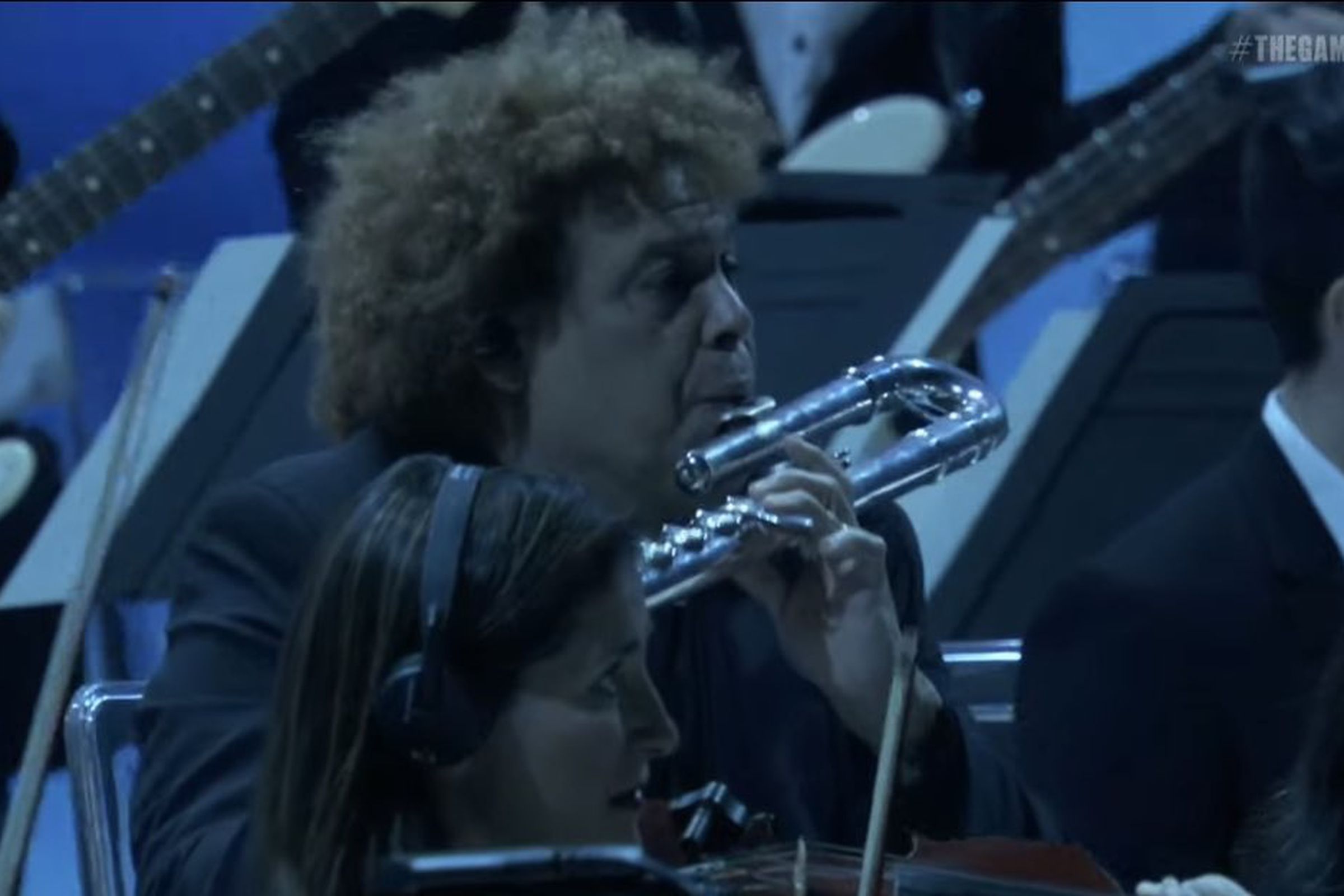 Screenshot from The Game Awards brodcast featuring a man with curly hair playing an alto flute