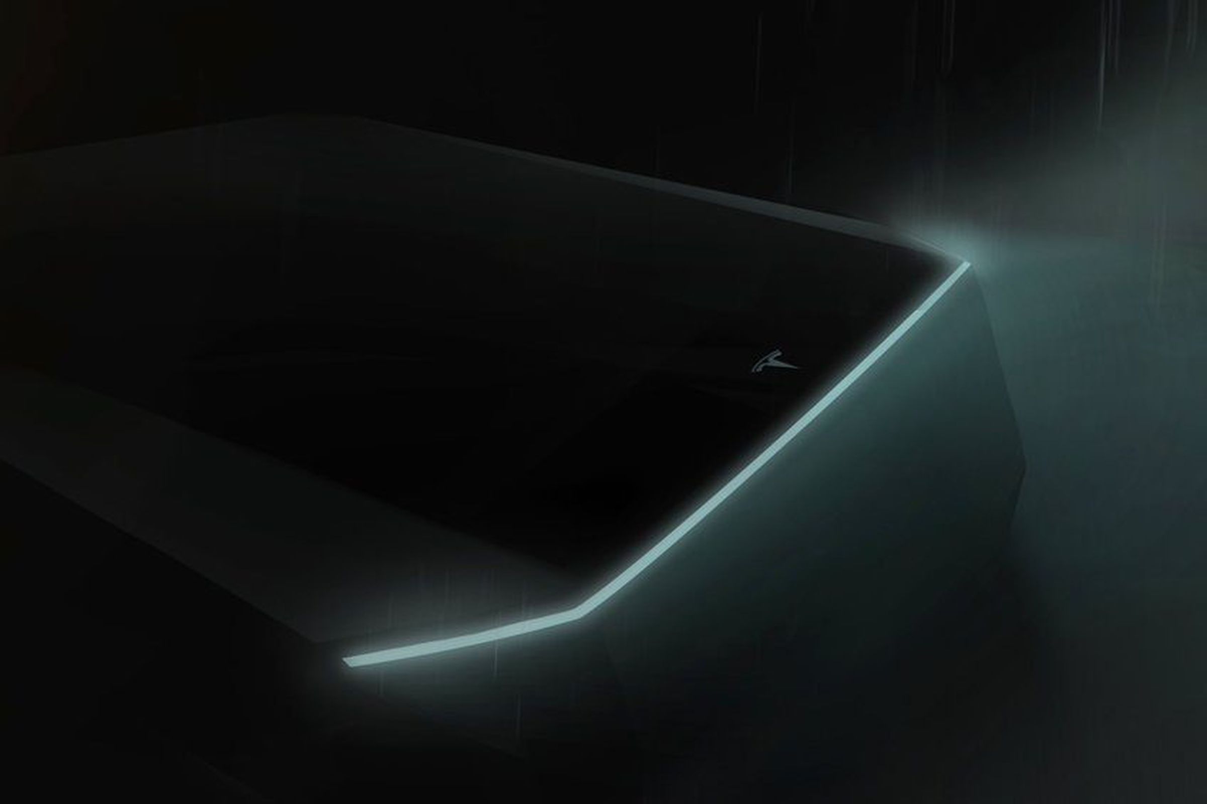The front of the Tesla pickup truck seen in a mostly indiscernible teaser image released earlier this year.