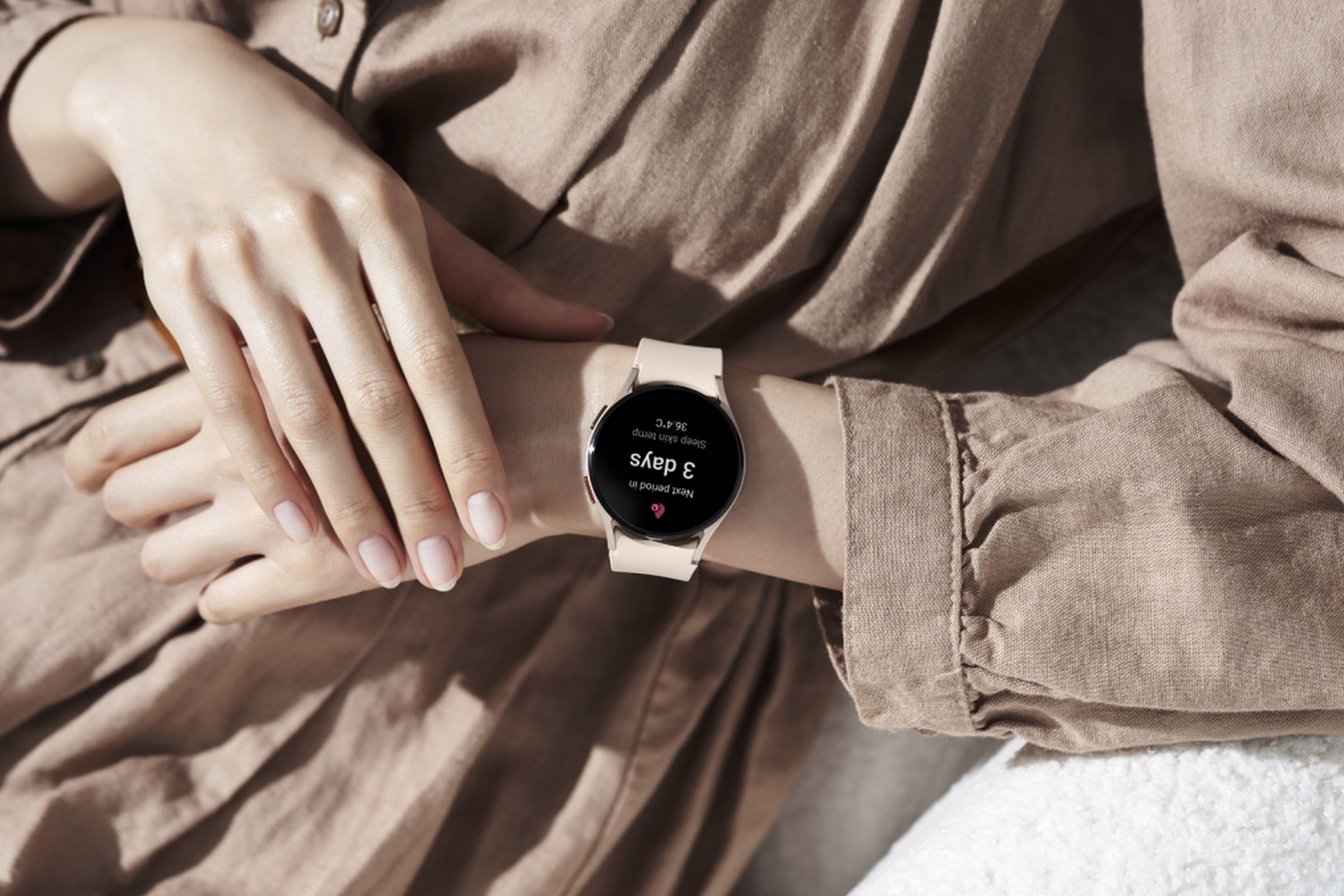 Woman wearing Samsung Galaxy Watch 5, which shows new cycle tracking features