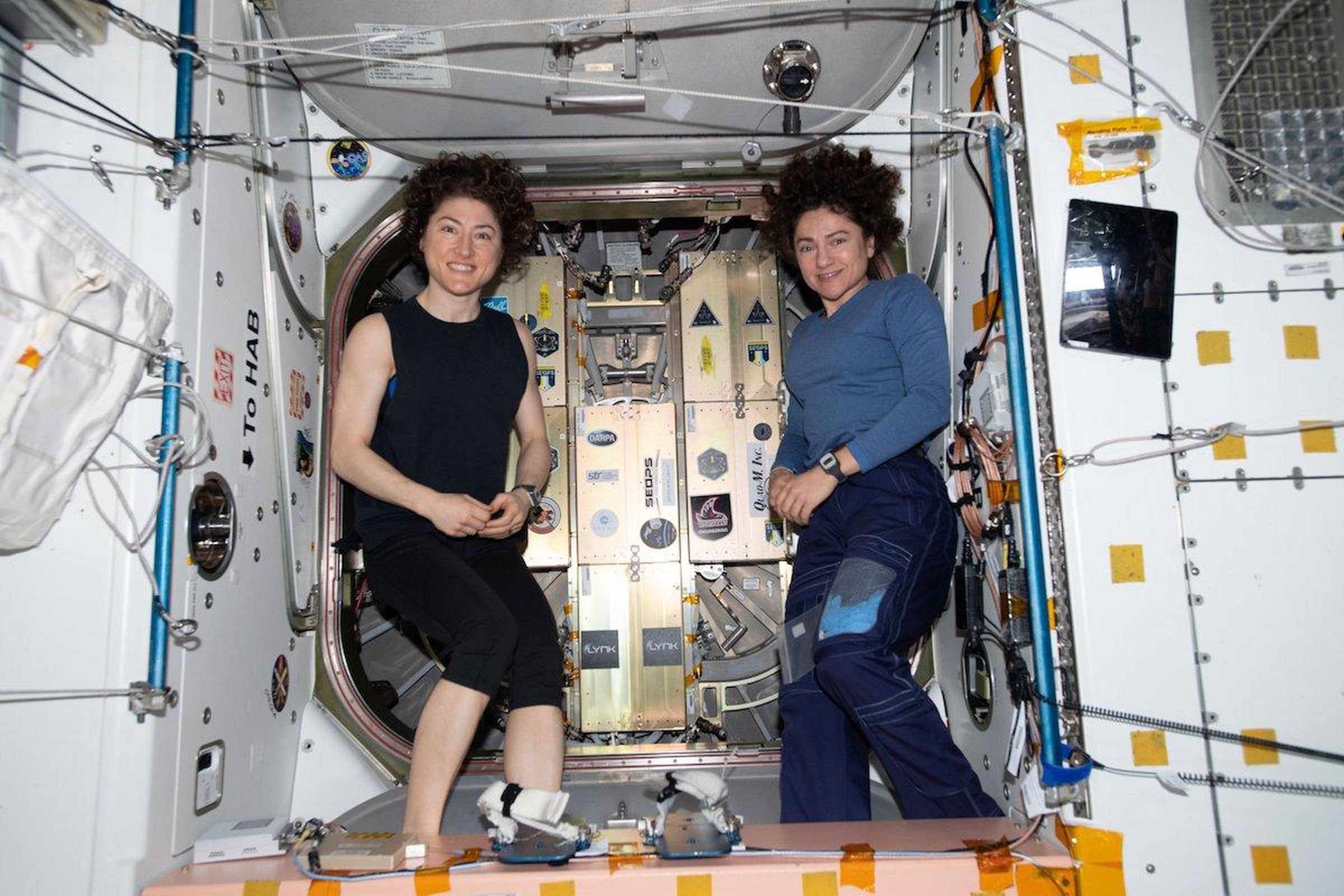 NASA astronauts Christina Koch (L) and Jessica Meir (R) after attaching the Lynk payload to the Cygnus cargo capsule