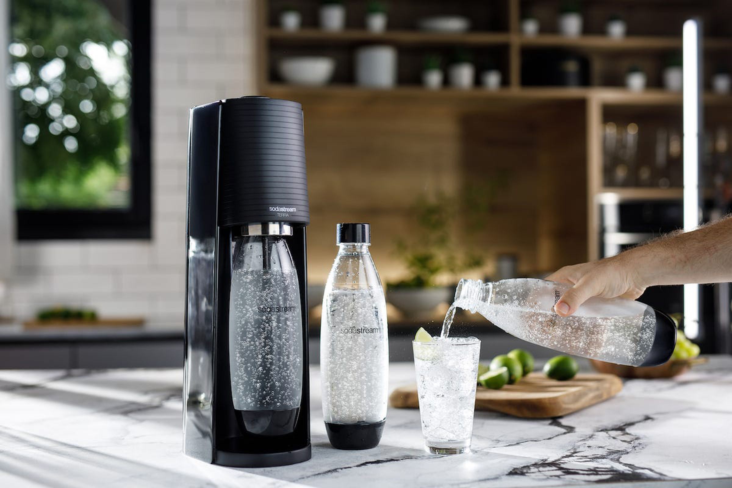 An image of a SodaStream and glass of sparkling water.