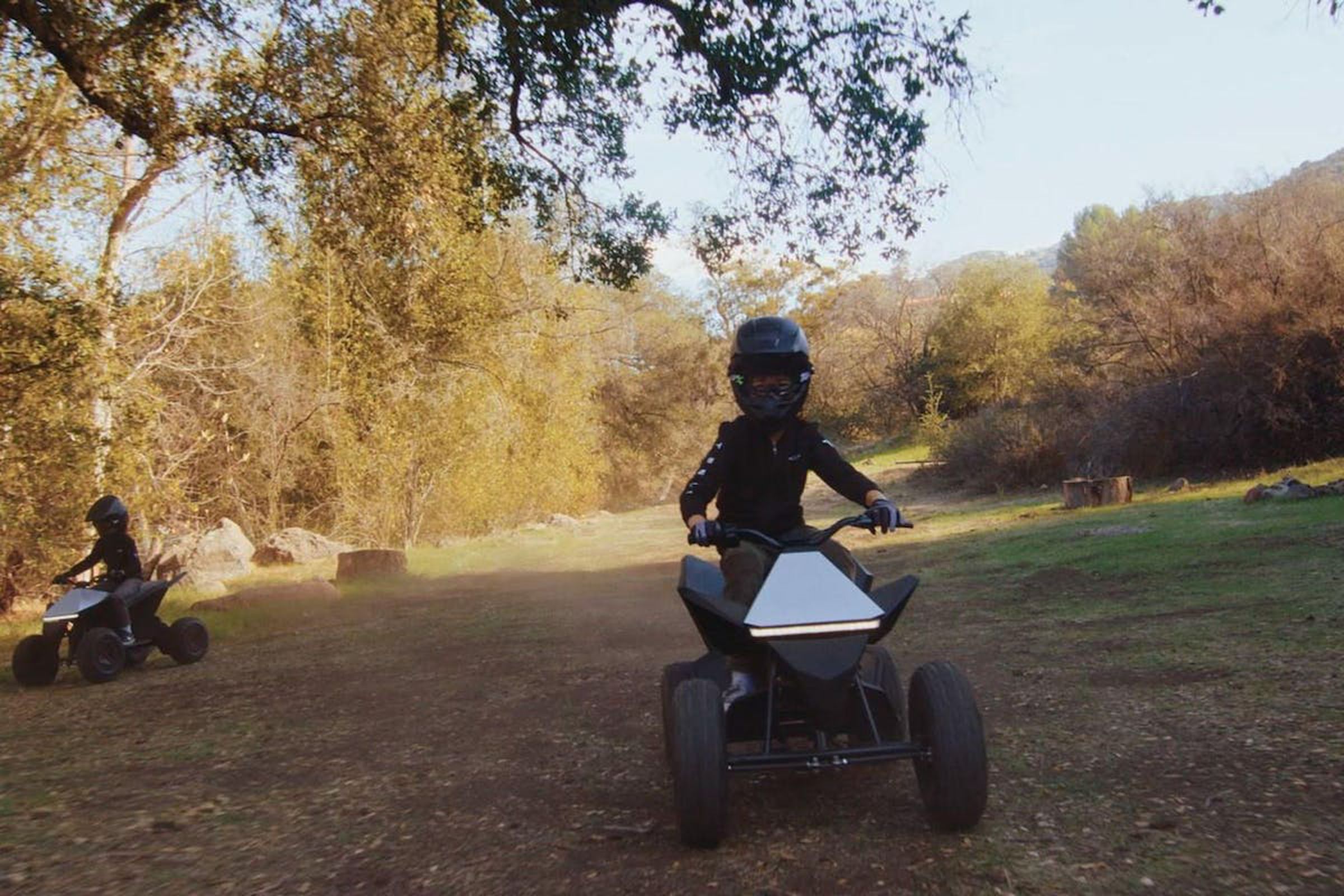 Photo of two kids in helmets riding the Cyberquad ATV.