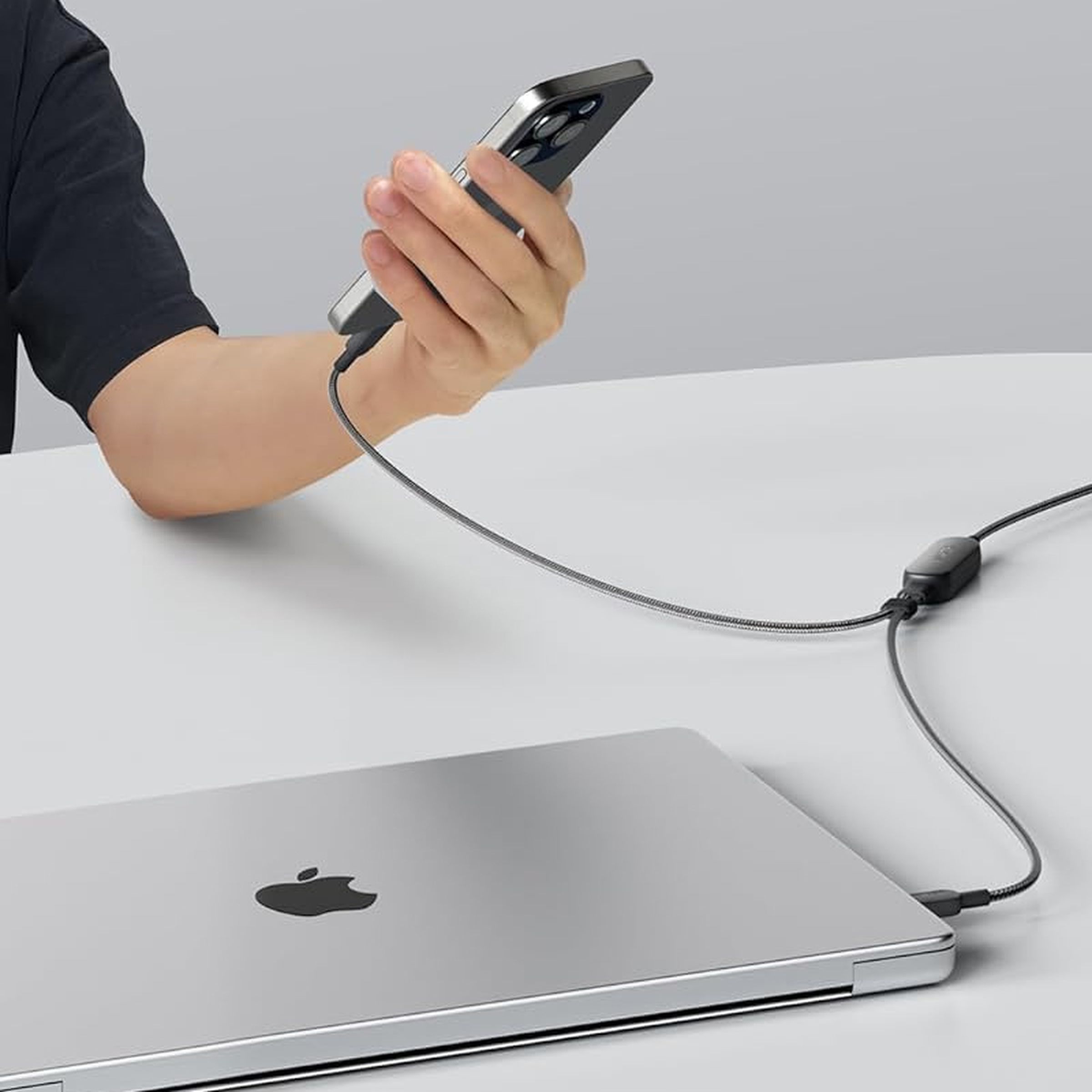 An Apple MacBook and iPhone being simultaneously charged using Anker’s new 2-in-1 USB-C cable.