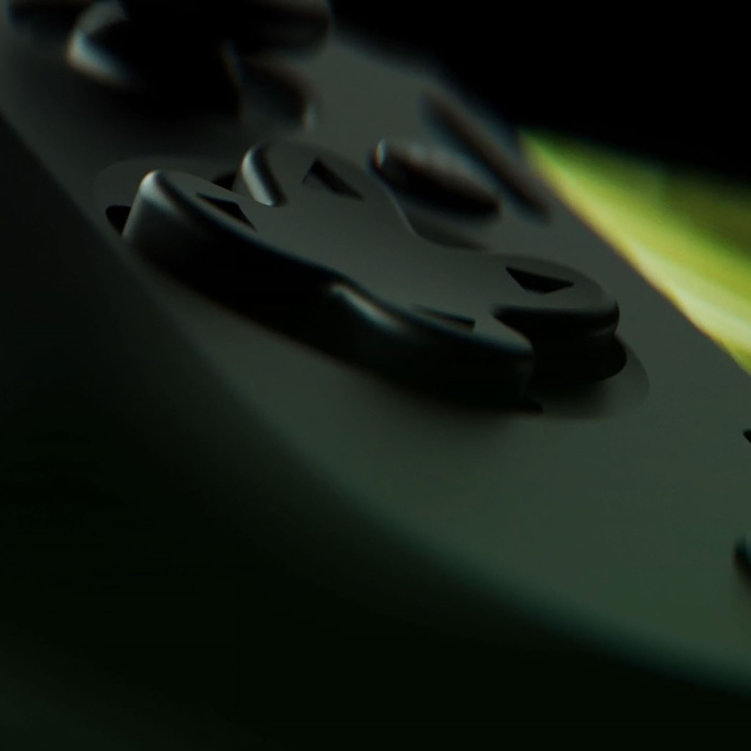 Close-up image of a d-pad, with a few buttons and a screen visible in the background.