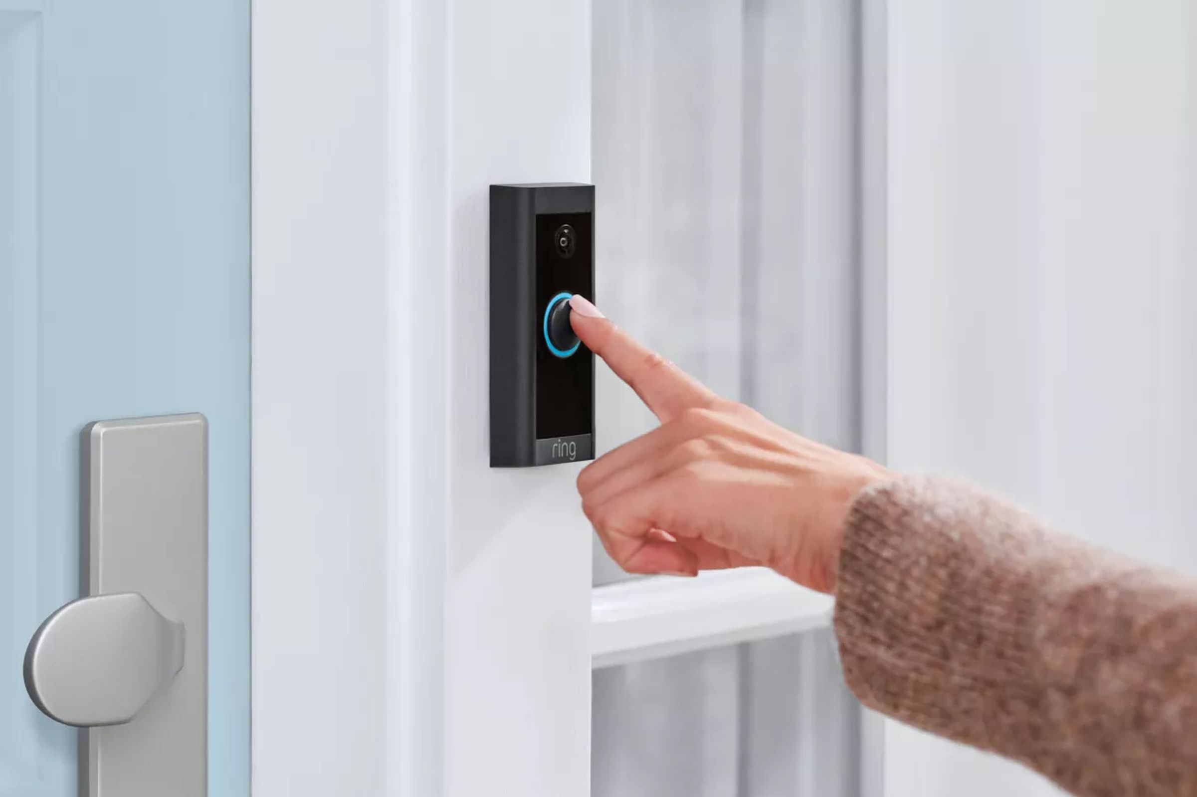 Outstretched Hand Pressing Ring Video Doorbell.