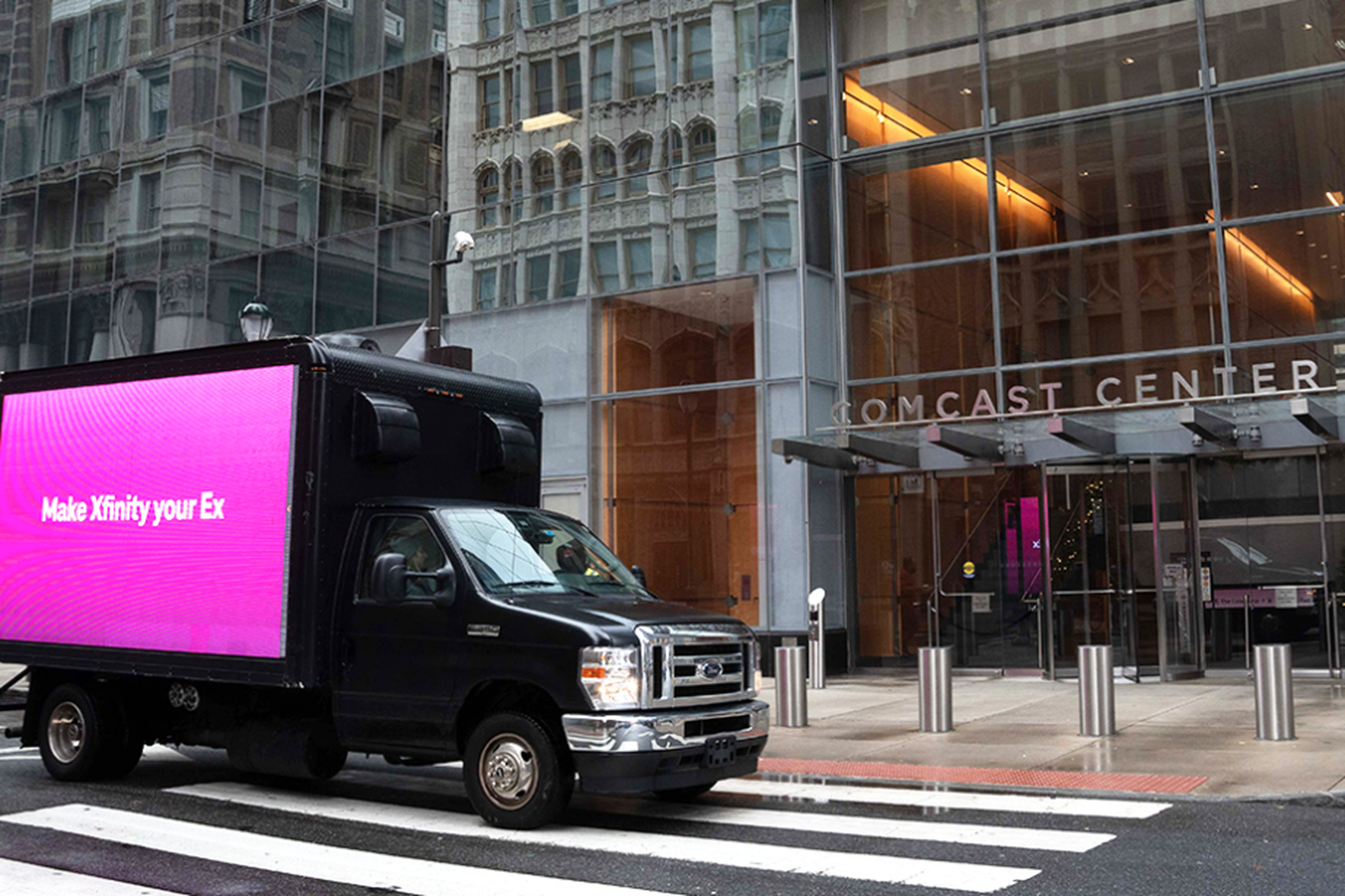 Photo of a T-Mobile billboard on a truck outside of Comcast Center. The billboard reads “Make Xfinity your ex”
