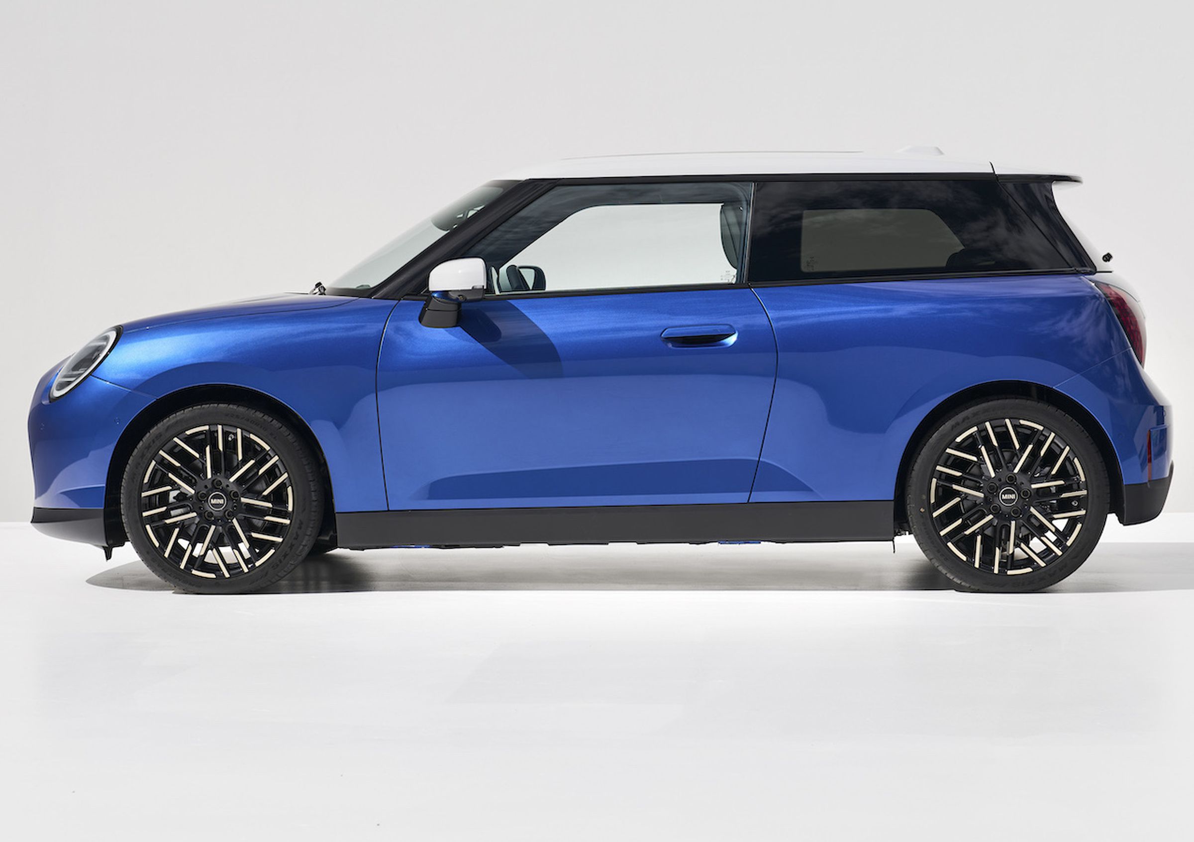 A sideview picture of a blue 2025 Mini Cooper.