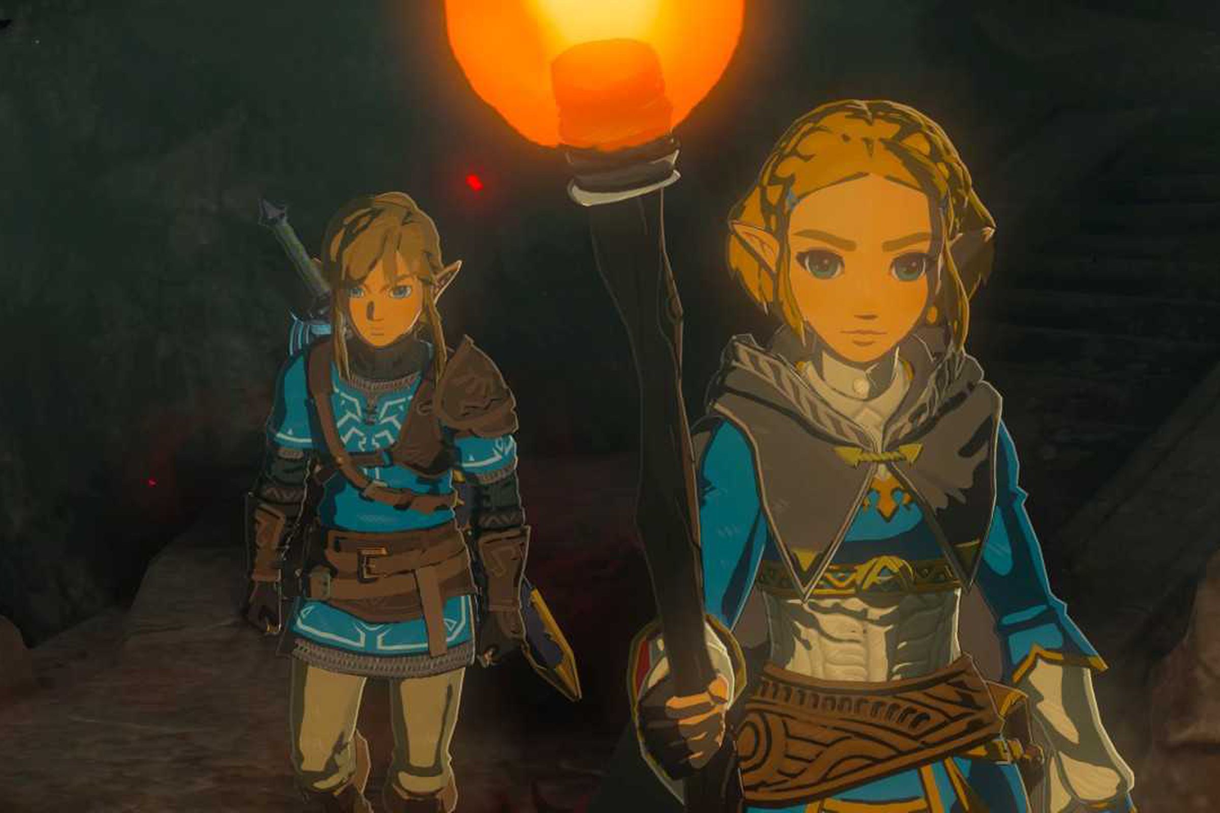 Screenshot from Tears of the Kingdom featuring Link and Zelda exploring a dark, torchlit cave