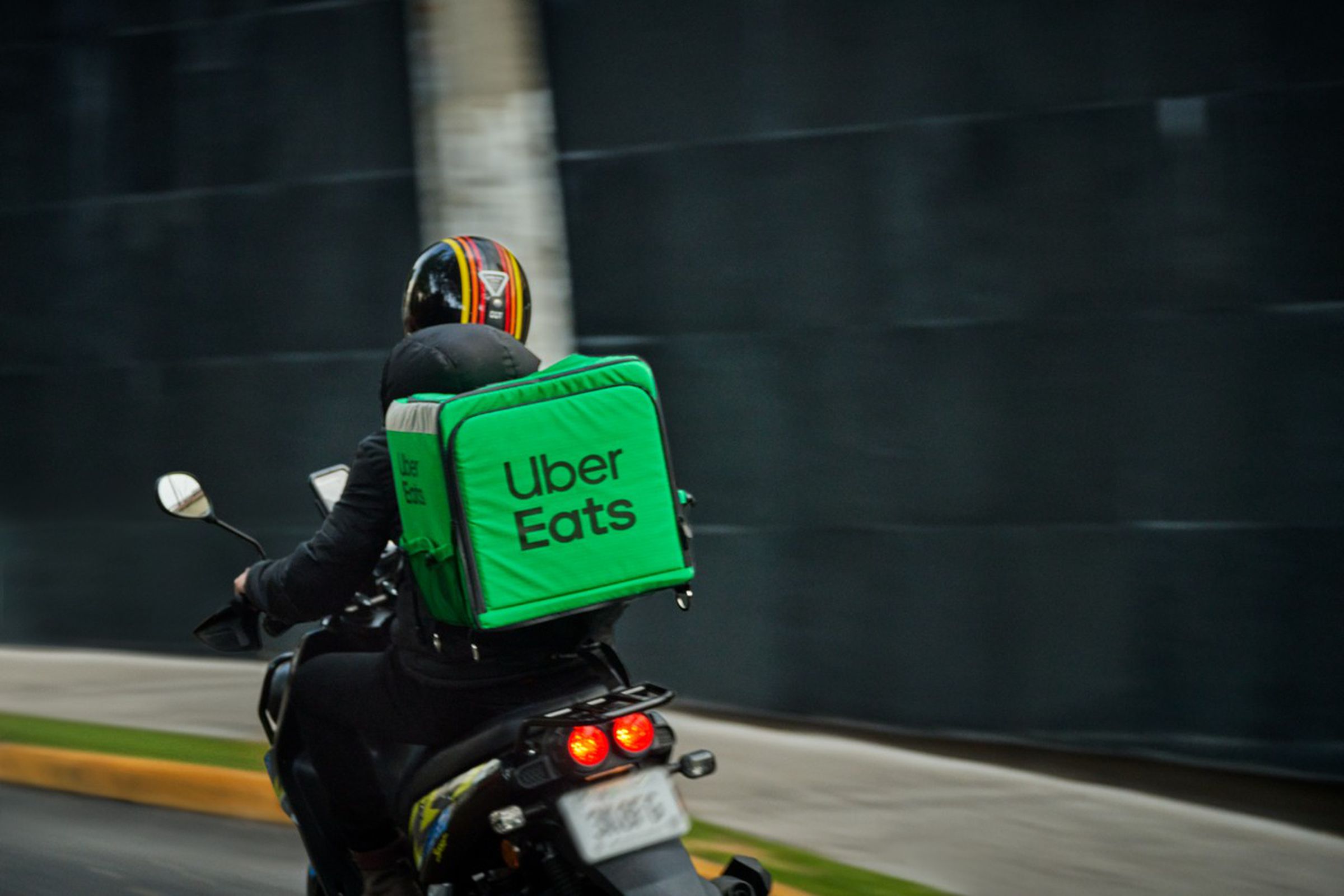 Uber Eats delivery courier on a moped