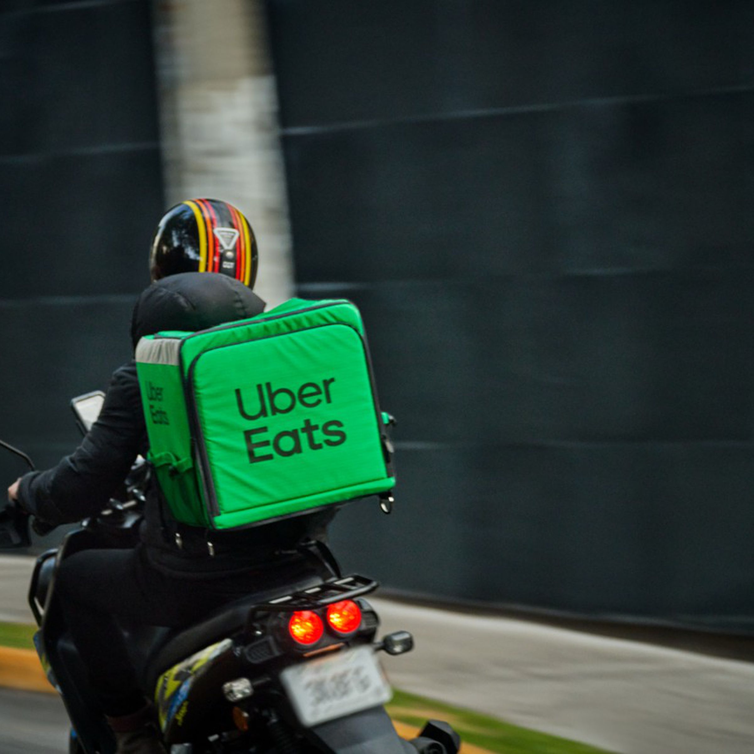 Uber Eats delivery courier on a moped