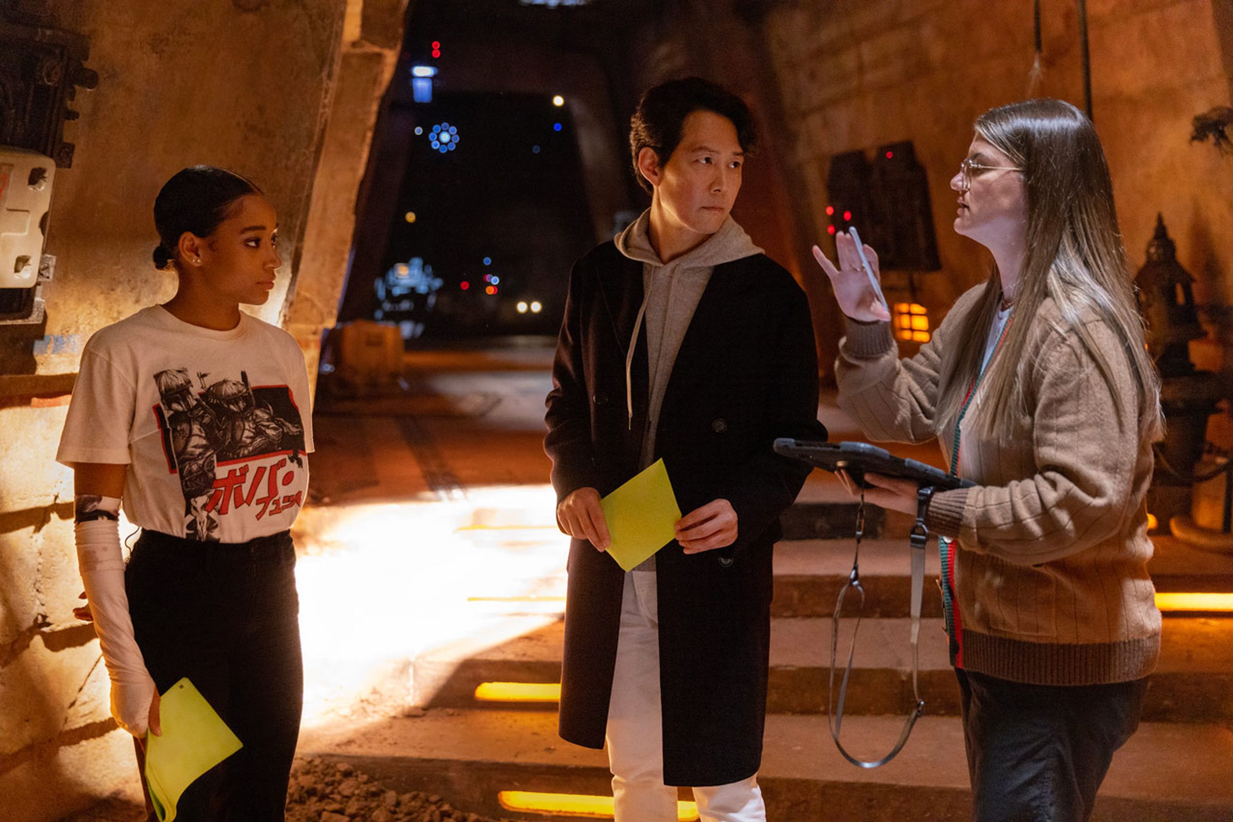 A photo of Amandla Stenberg, Lee Jung-jae, and Leslye Headland on the set of The Acolyte.