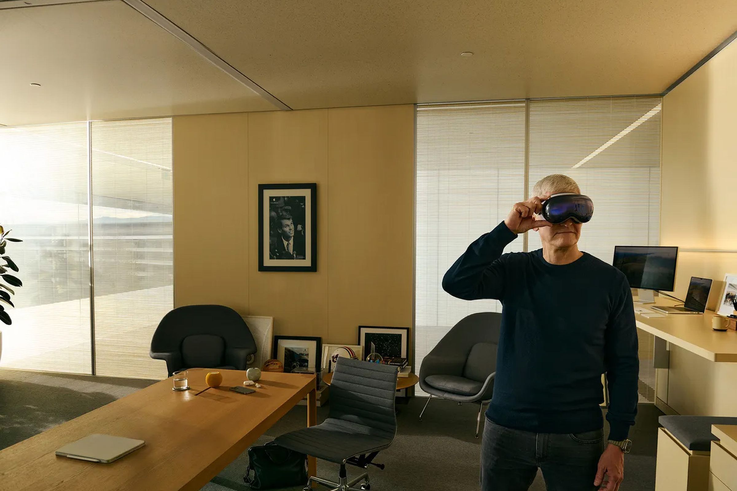 Tim Cook wearing Vision Pro in office setting.