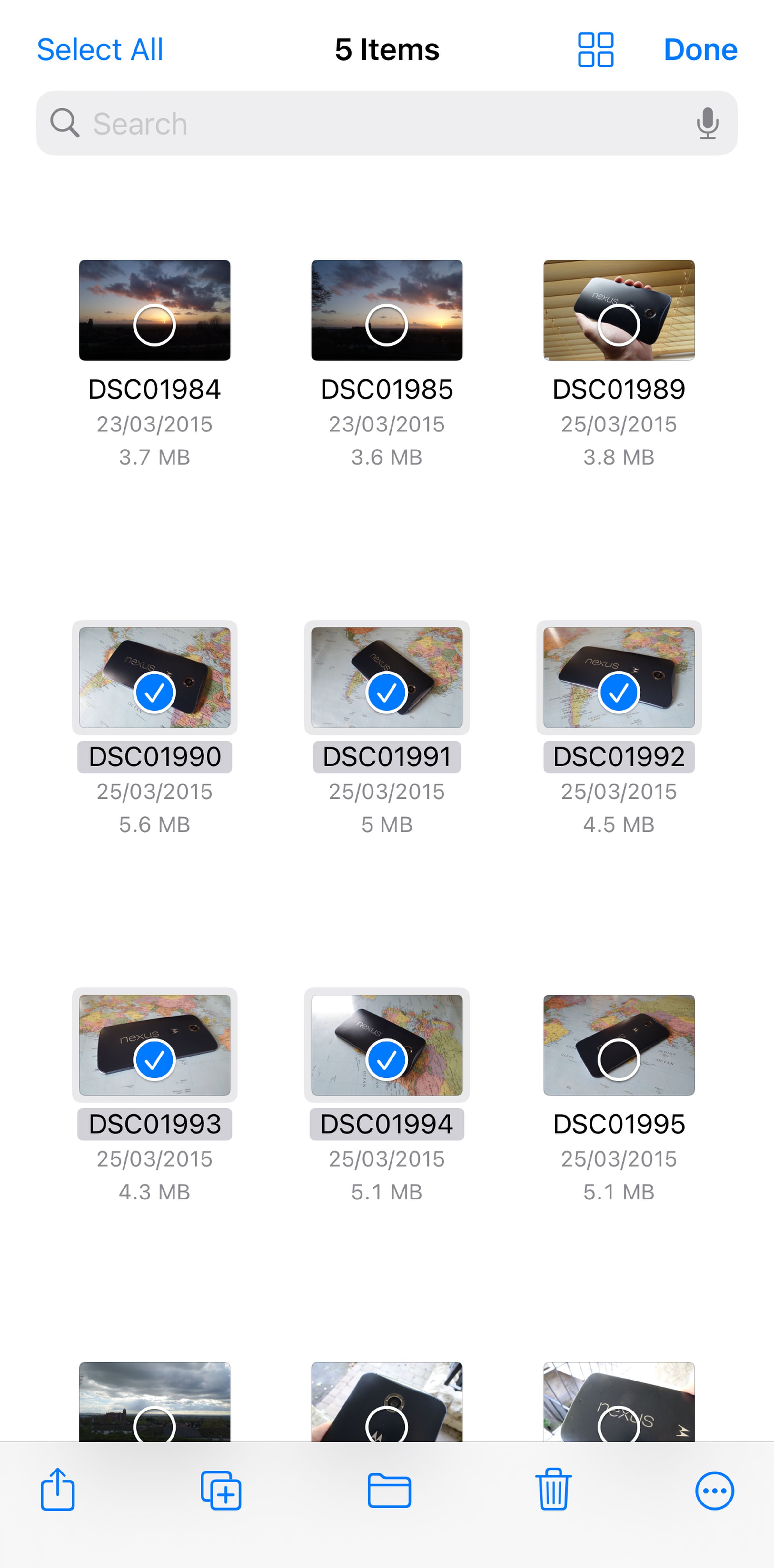 Thumbnails of various photos, some of which have blue checks in front of them.