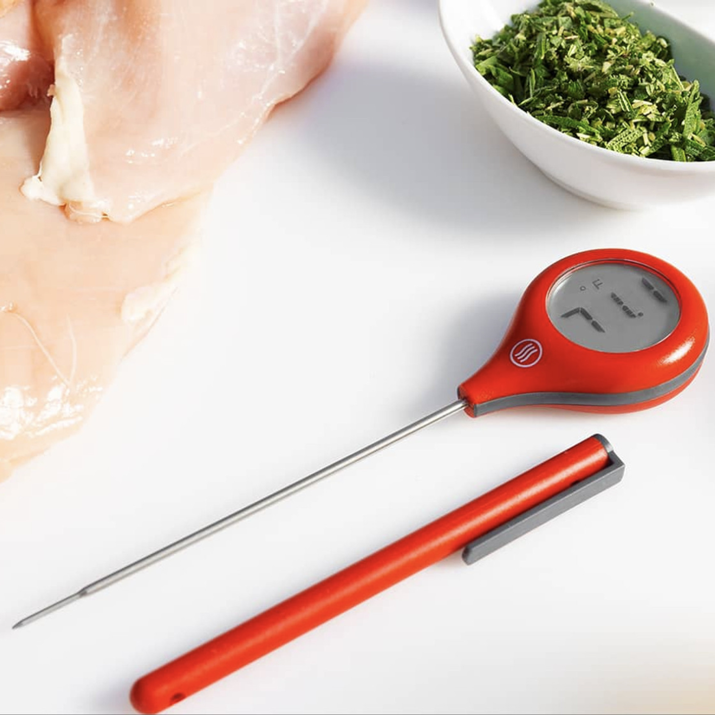 Digital thermometer and cover on table top.