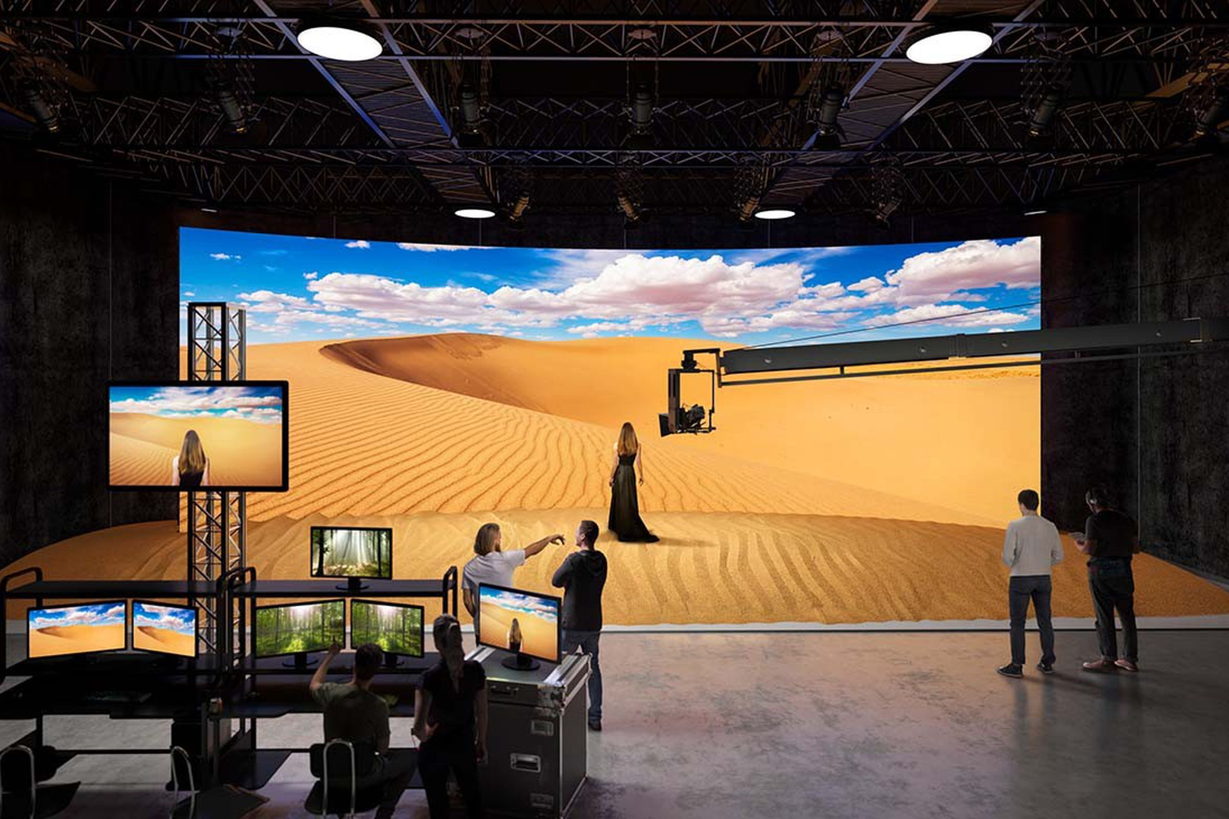 Image of an actress standing in front of a display wall being used as a virtual set