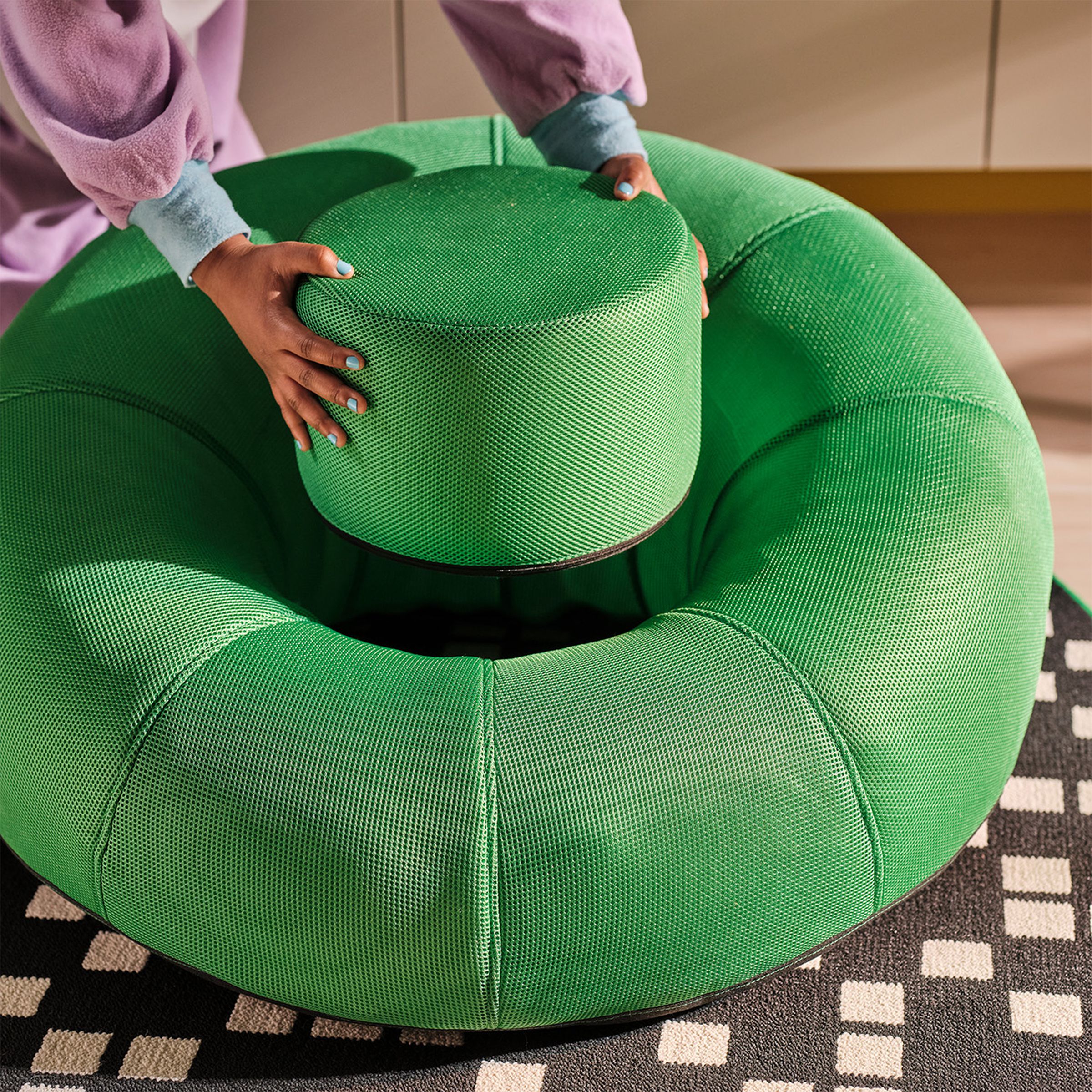 The inflatable donut chair comes with a footstool that slots neatly away into the chair itself.