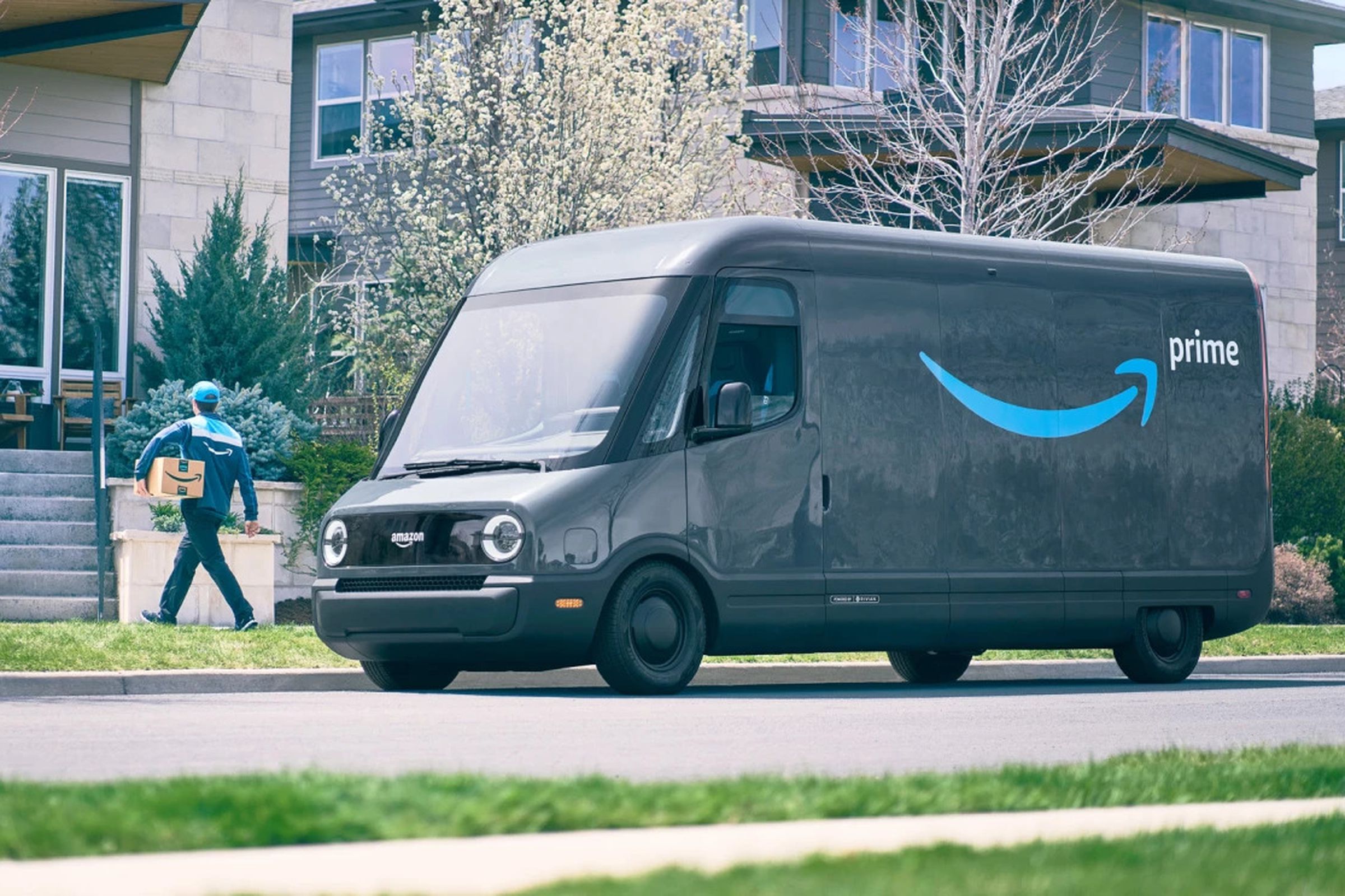 An image showing a Rivian van with Amazon branding parked in front of someone’s house