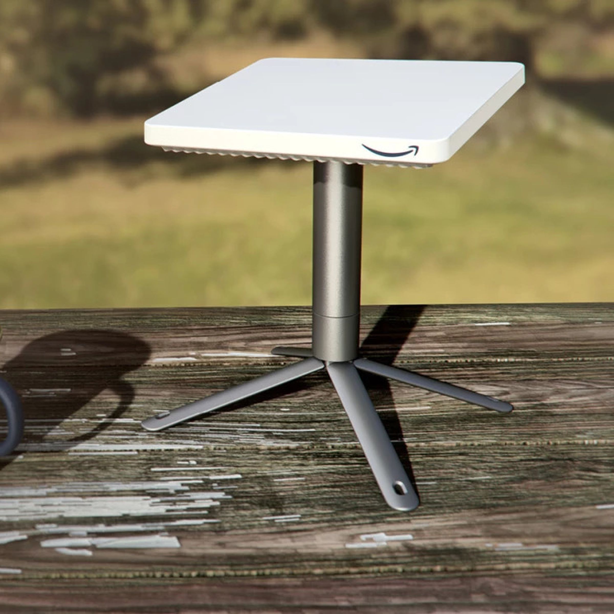 An image showing Amazon’s compact Project Kuiper satellite dish on a table