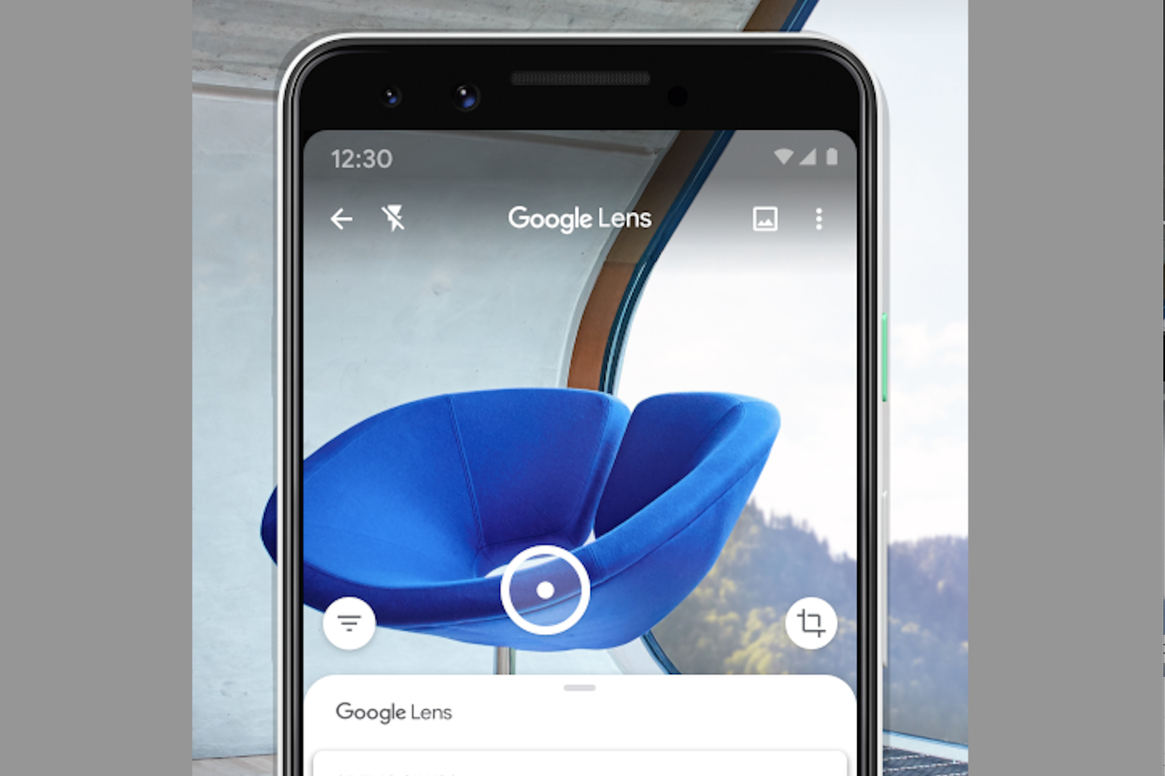 Blue chair viewed through a phone using Google Lens.