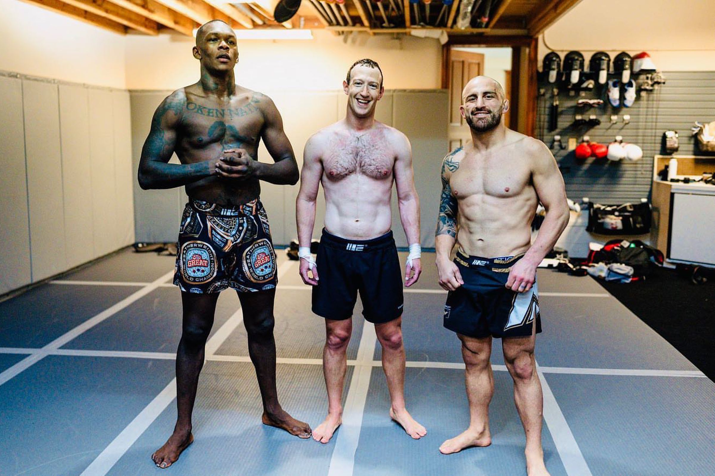 A photo of Mark Zuckerberg in his home gym with UFC champions Israel Adesanya and Alexander Volkanovski.