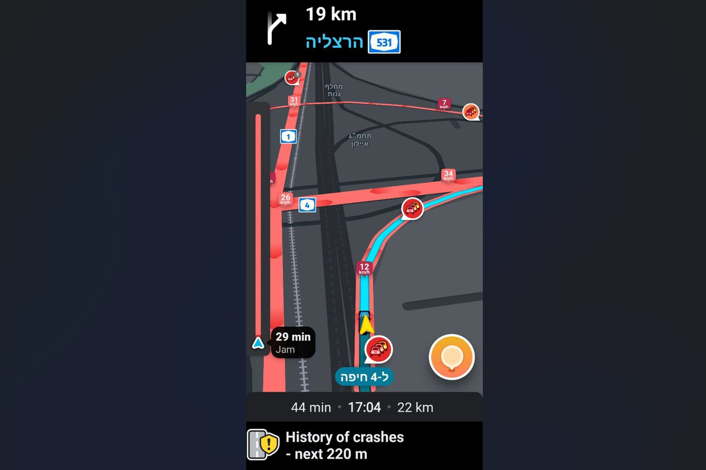 This is a screenshot of the Waze app while navigating a highway exit in Israel, showing the roads as red due to a history of crashes.