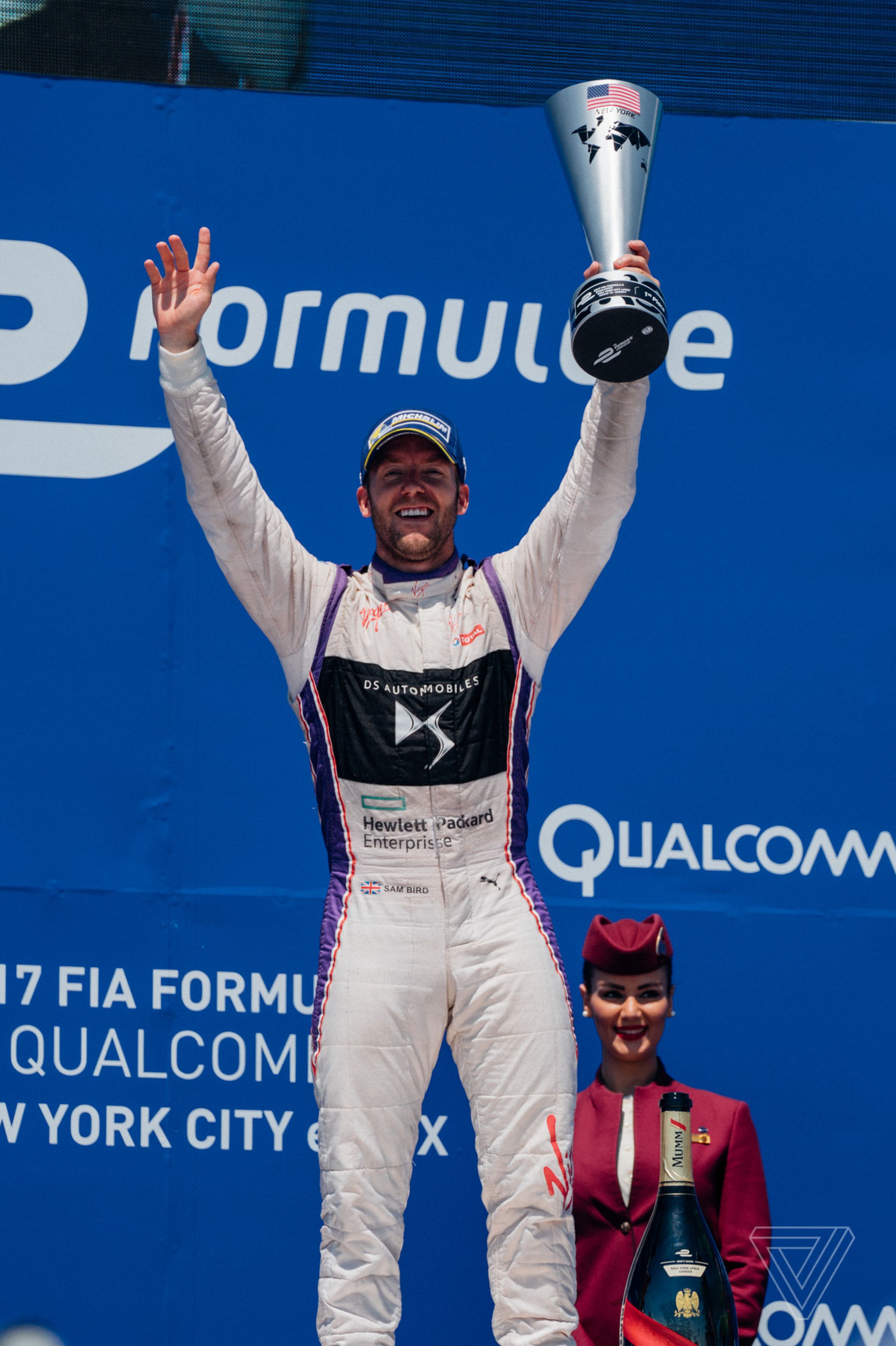 Sam Bird hoists the trophy after winning the second Formula E race in New York City. 